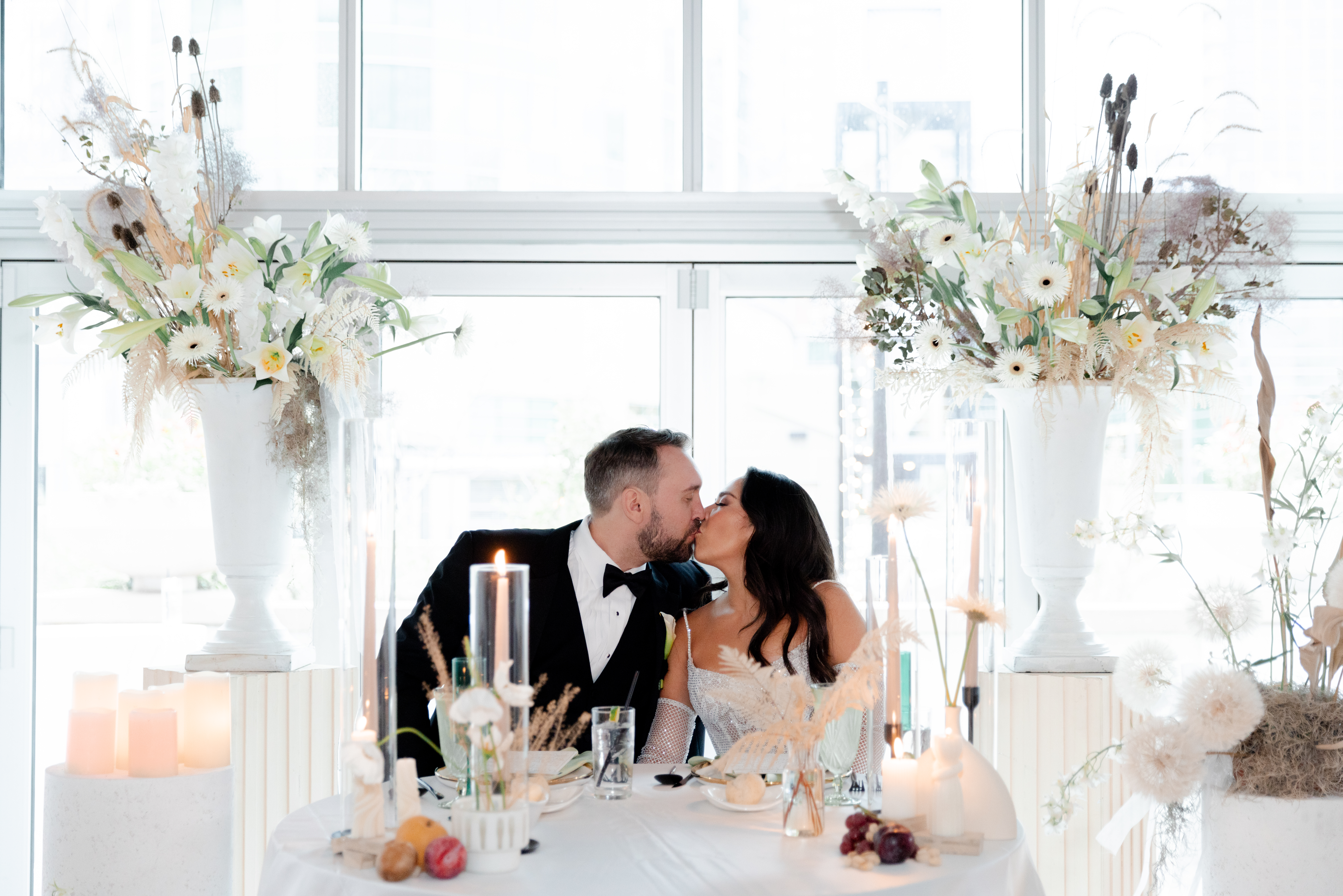 Husband and bride share a kiss on their wedding day. 