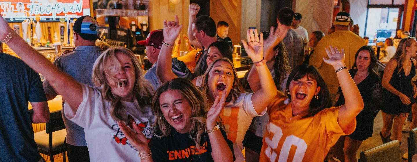 Group of women in University of Tennessee shirts at DraftKings Sports & Social, Nashville Live!