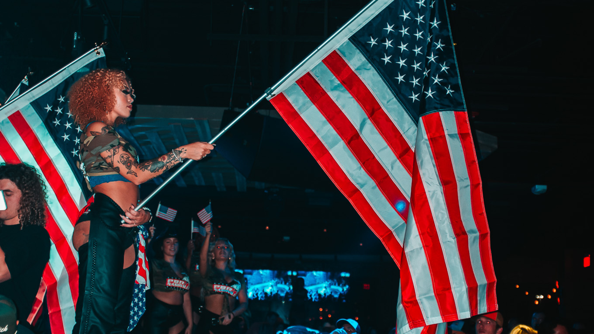 PBR Buckle Bunny holding large American flag.