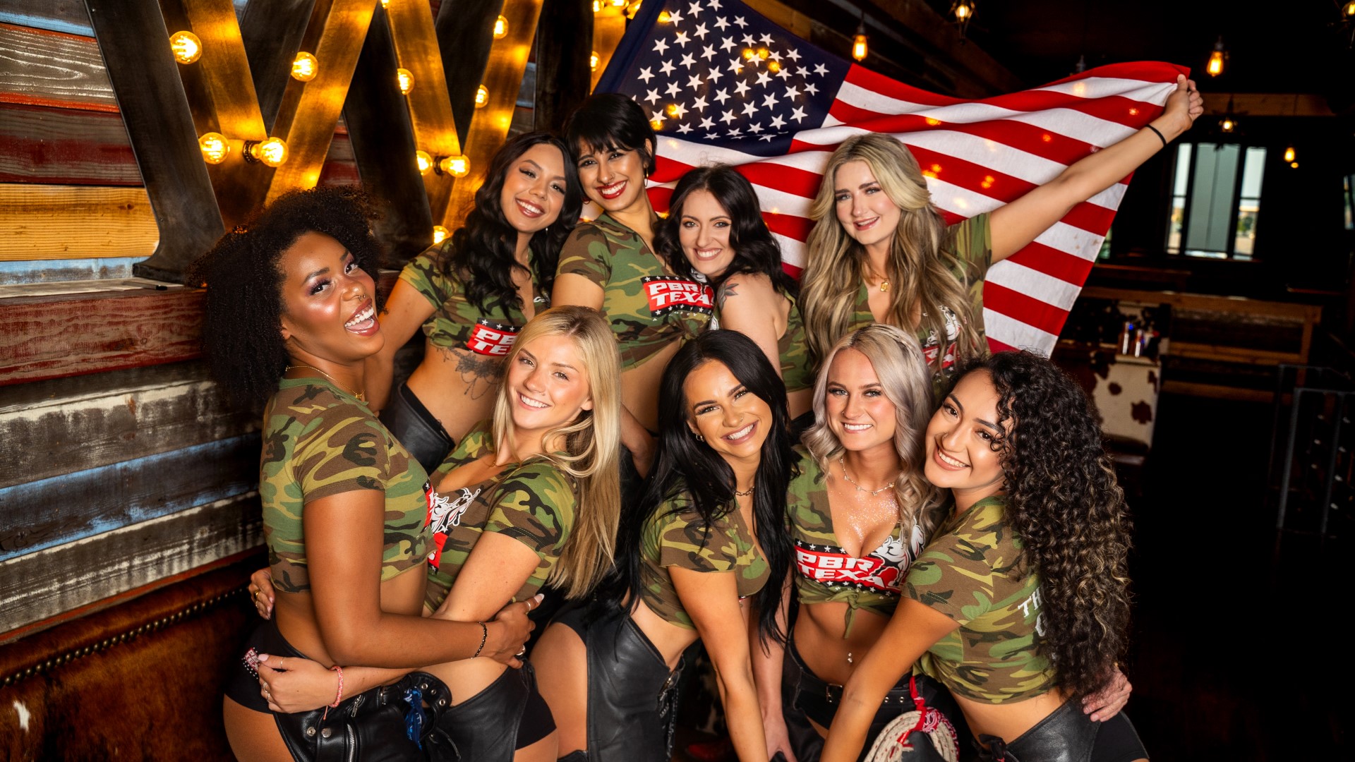 PBR Buckle Bunnies in front of an American flag.