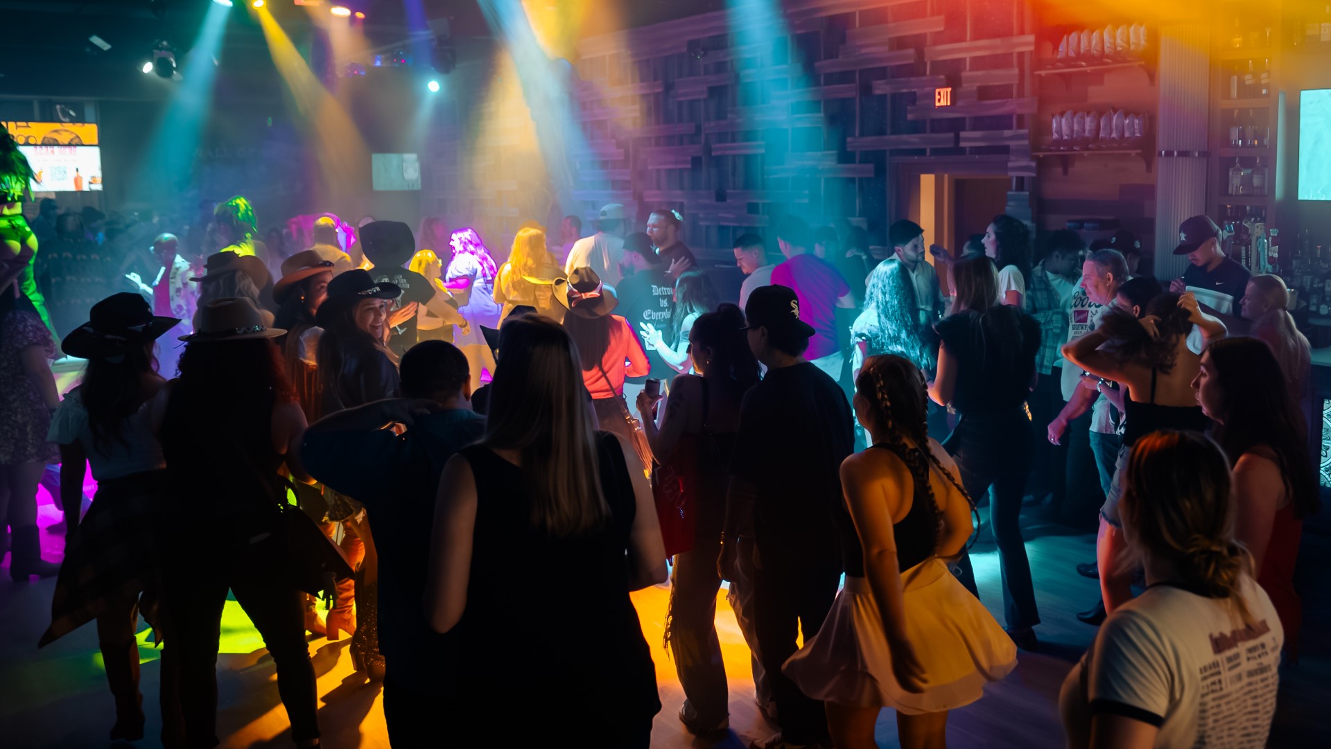 Crowd line dancing at PBR Cowboy Bar at Live! at the Pointe Orlando.