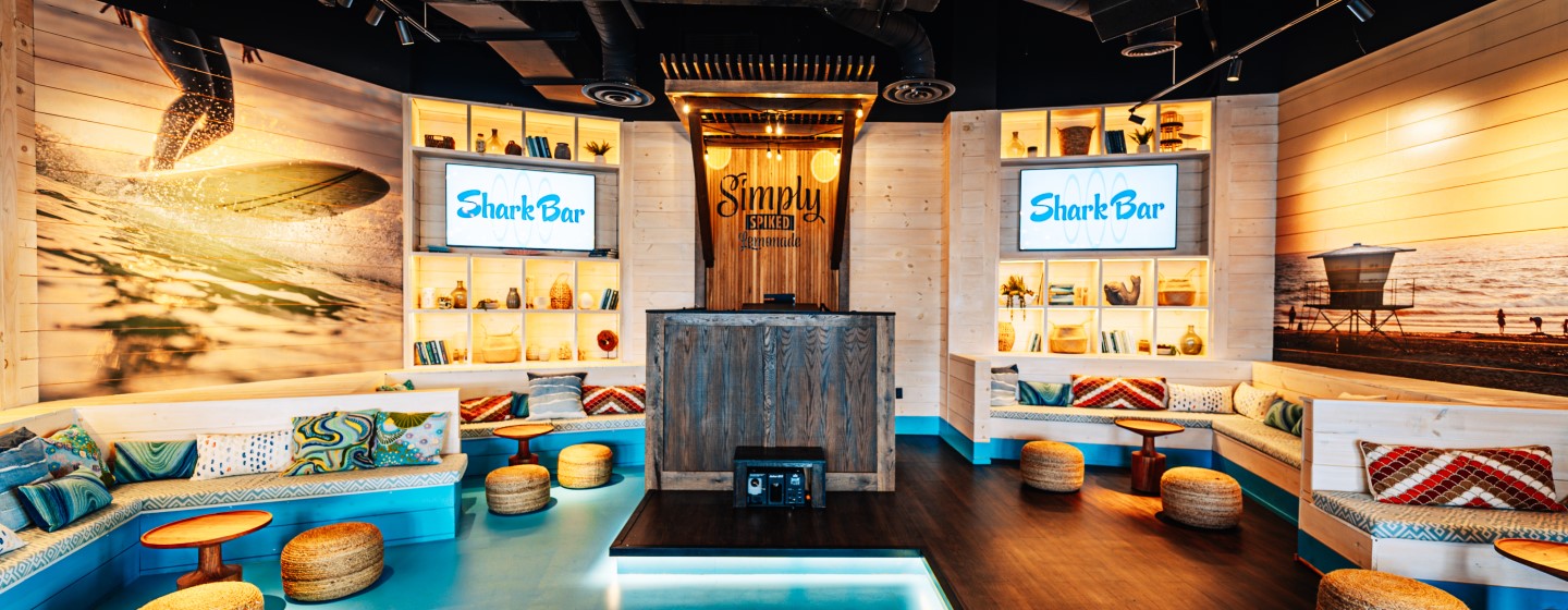 DJ booth and lounge seating at Shark Bar at Live! at the Pointe Orlando.