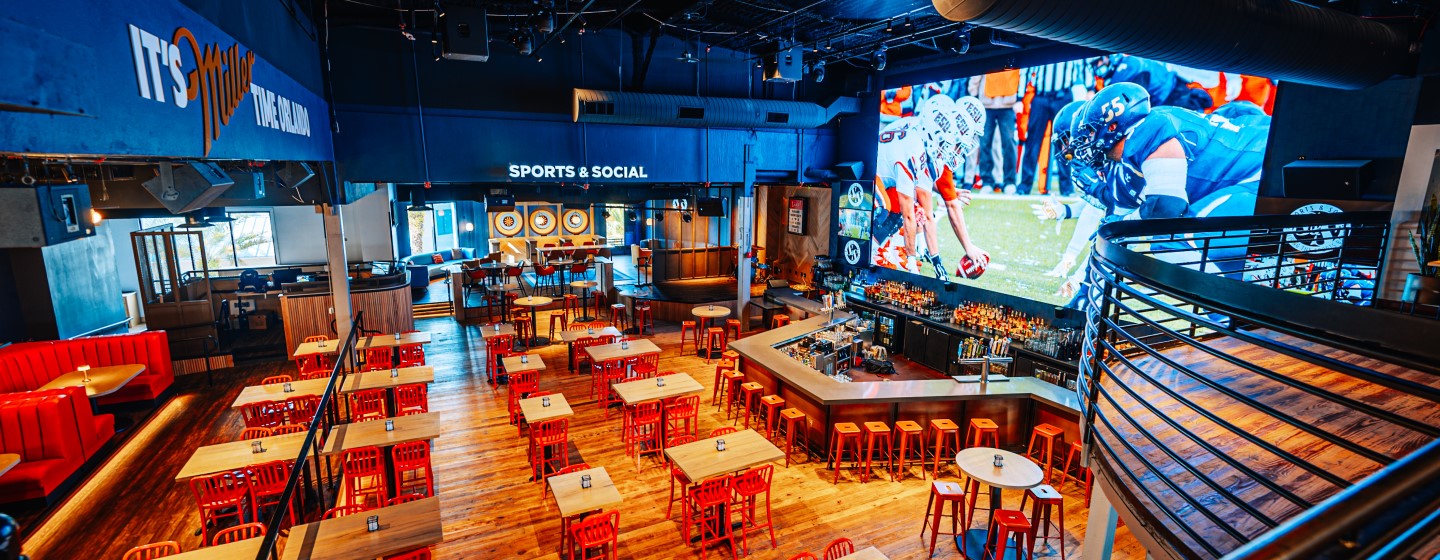 View from upper level of first floor dining and bar area at Sports & Social at Live! at the Pointe Orlando.