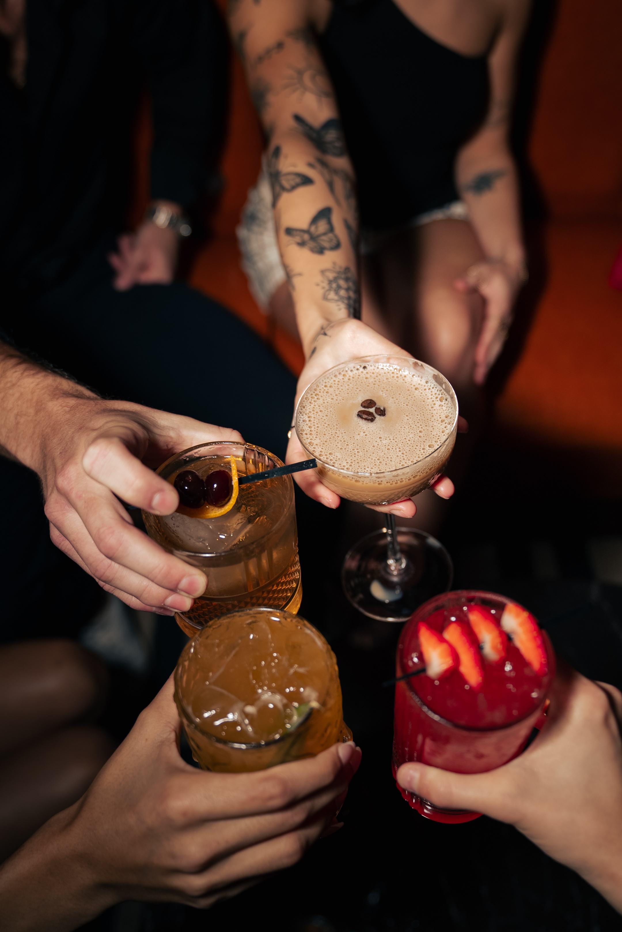 Group enjoying night out and toasting cocktails.