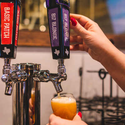 817 Blonde beer being poured into pint glass from tap.