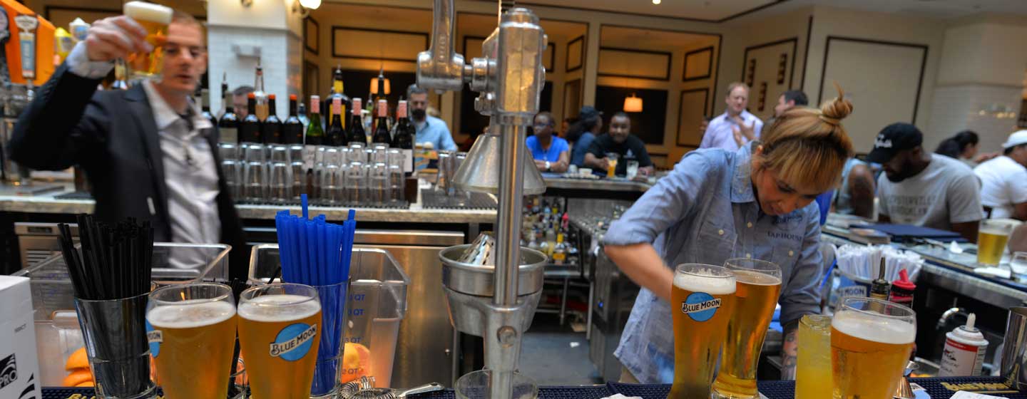 Bartender working behind bar at Blue Moon Taphouse