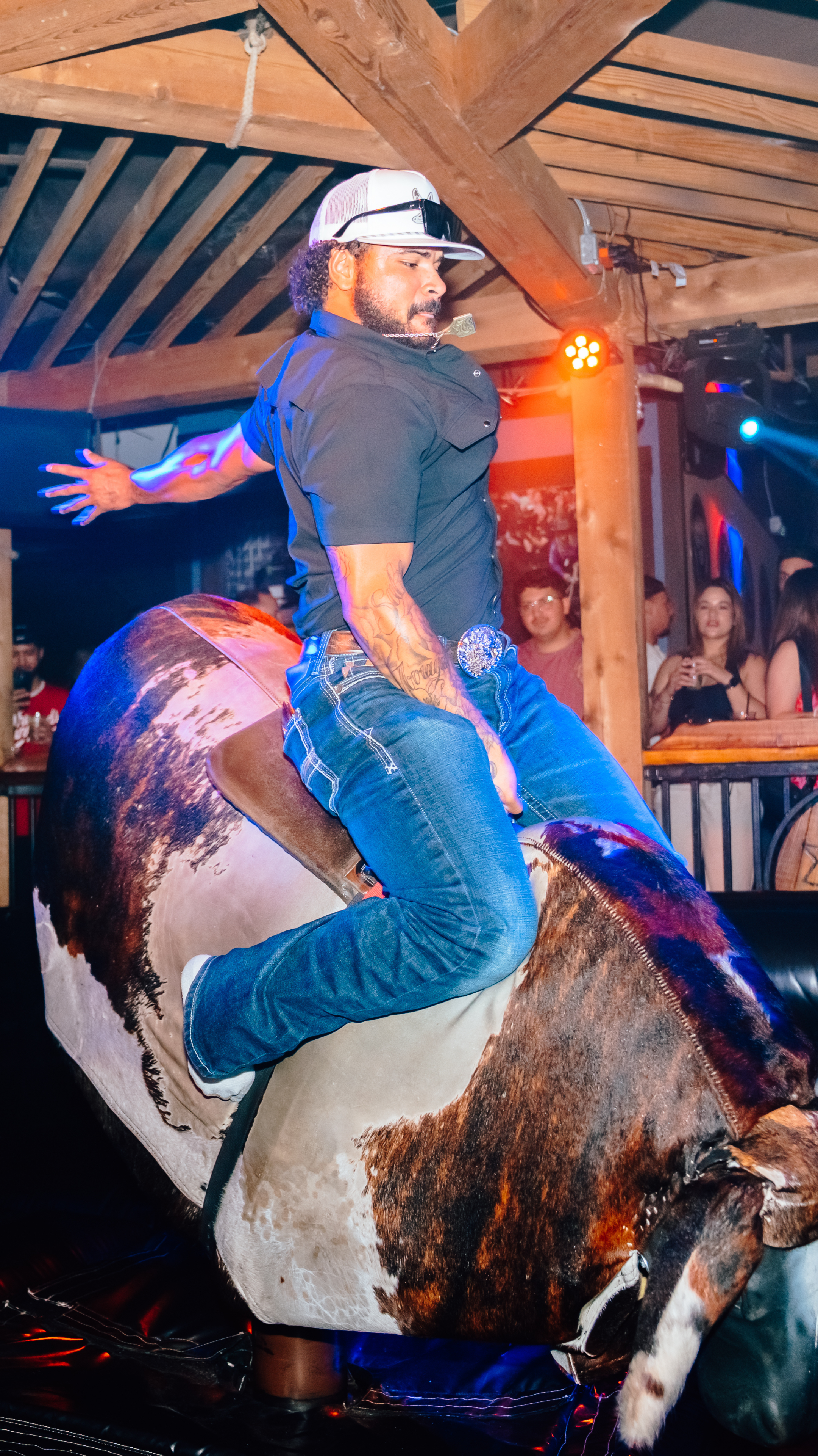 An image of a guy riding the mechanical bull.