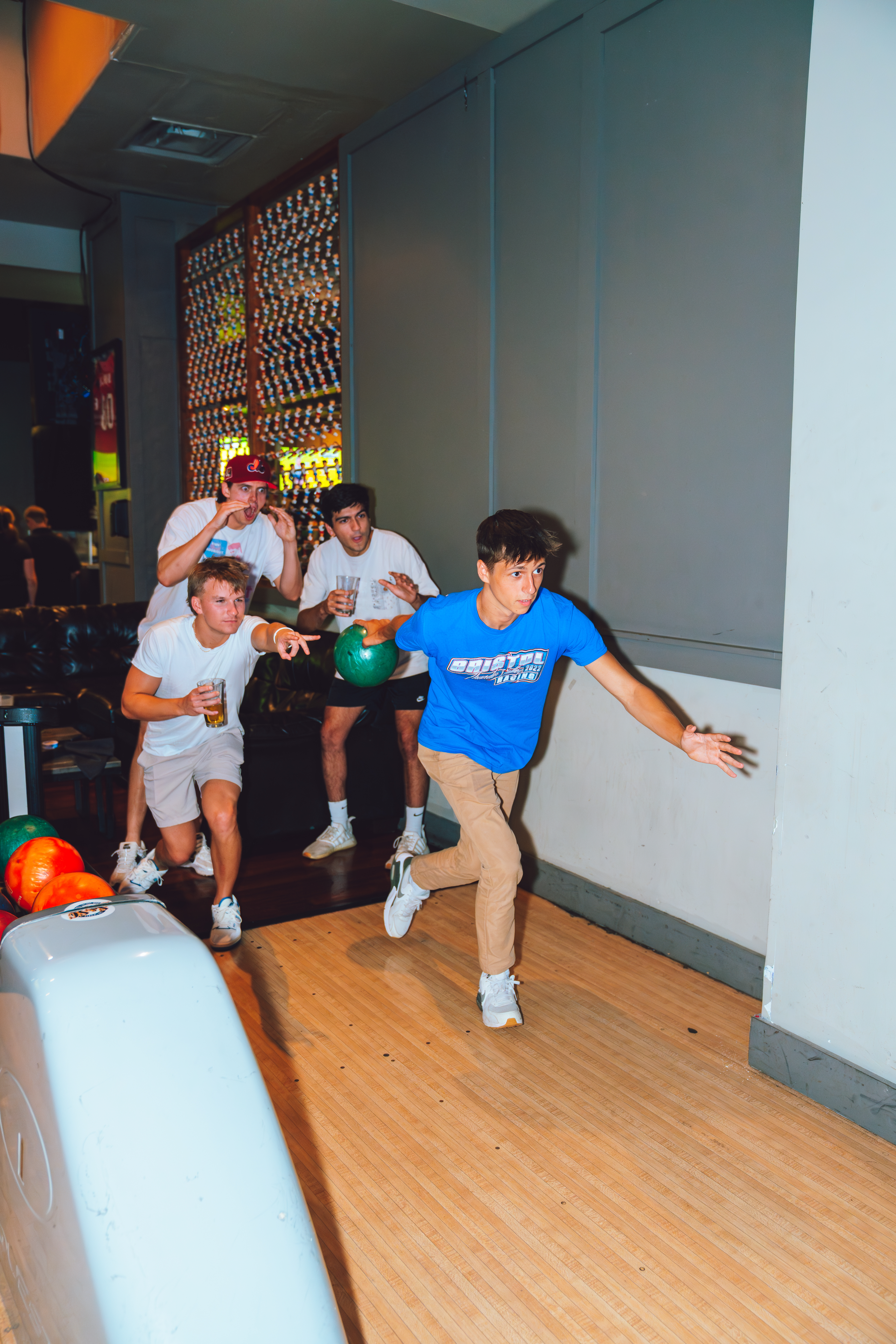 An image of 4 guys bowling at Sports and Social.