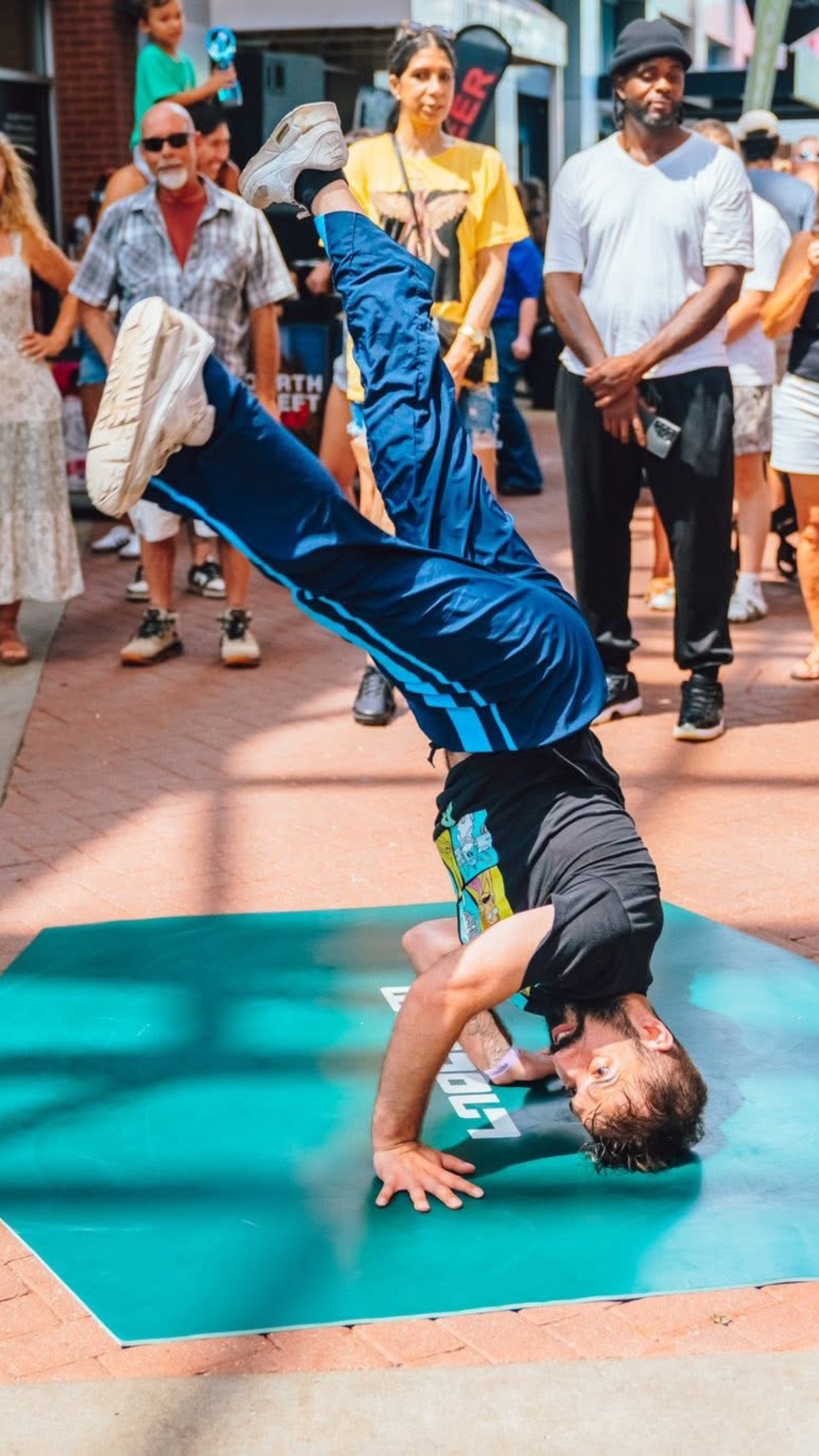 An image of a man breakdancing at the Street Food Fest.