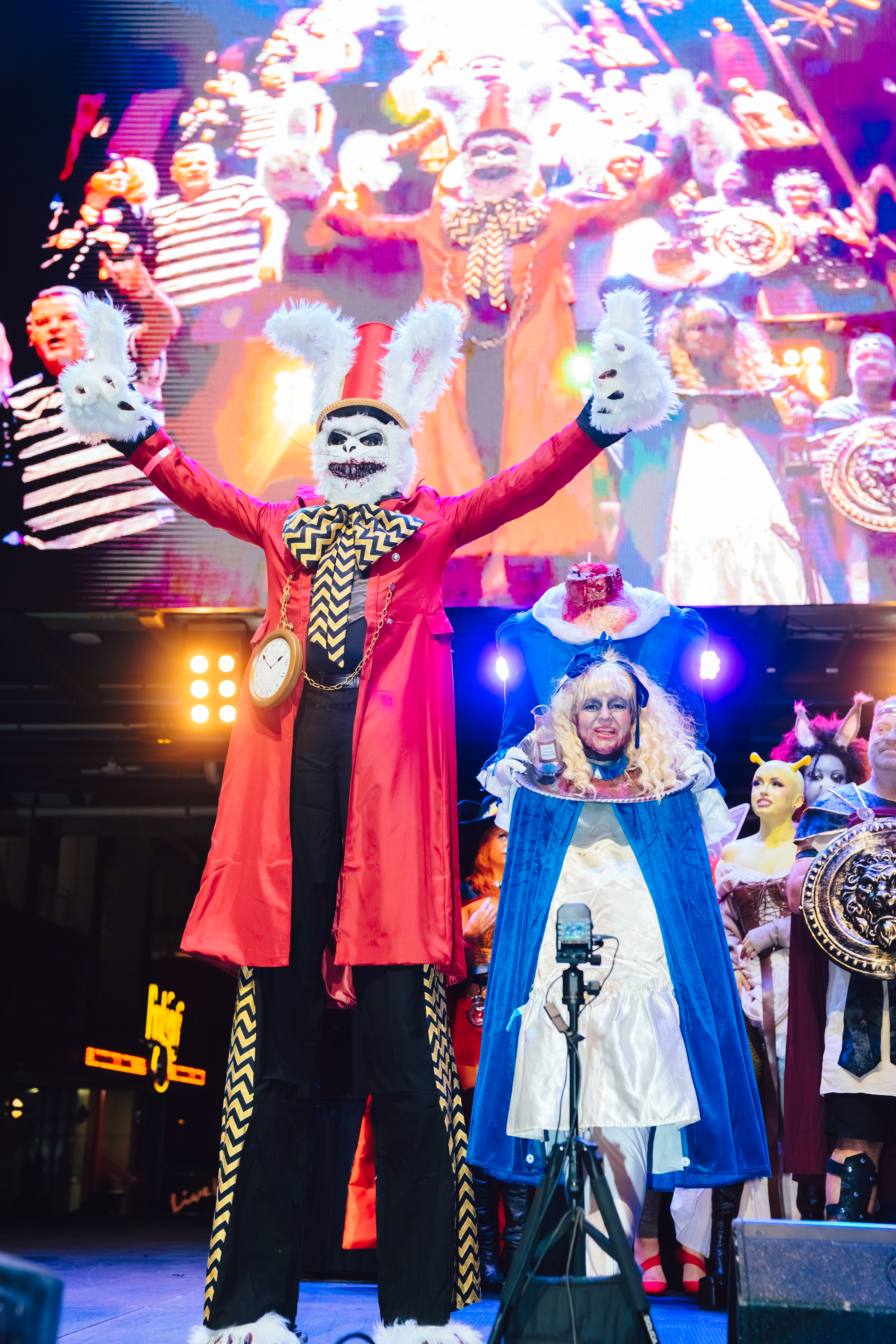 AN image of two people dressed up in costumes and standing on stage.