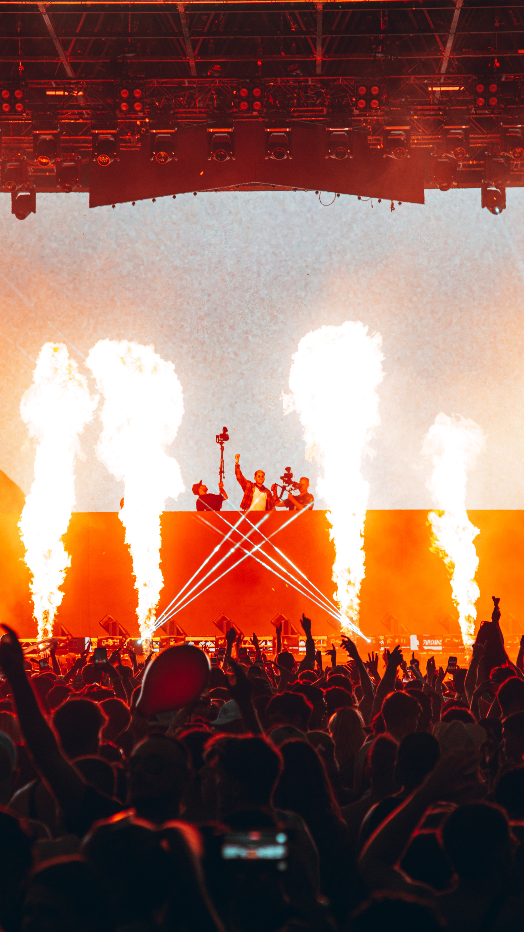An image of the artist, D.O.D., performing with flames going up on both sides of the stage.