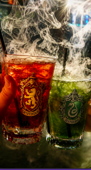 An image of a red and green drink with smoke rising from them.