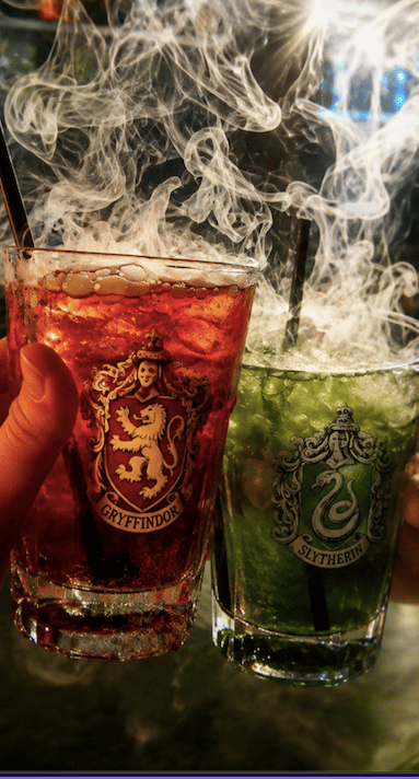 An image of a red and green drink with smoke rising from them.