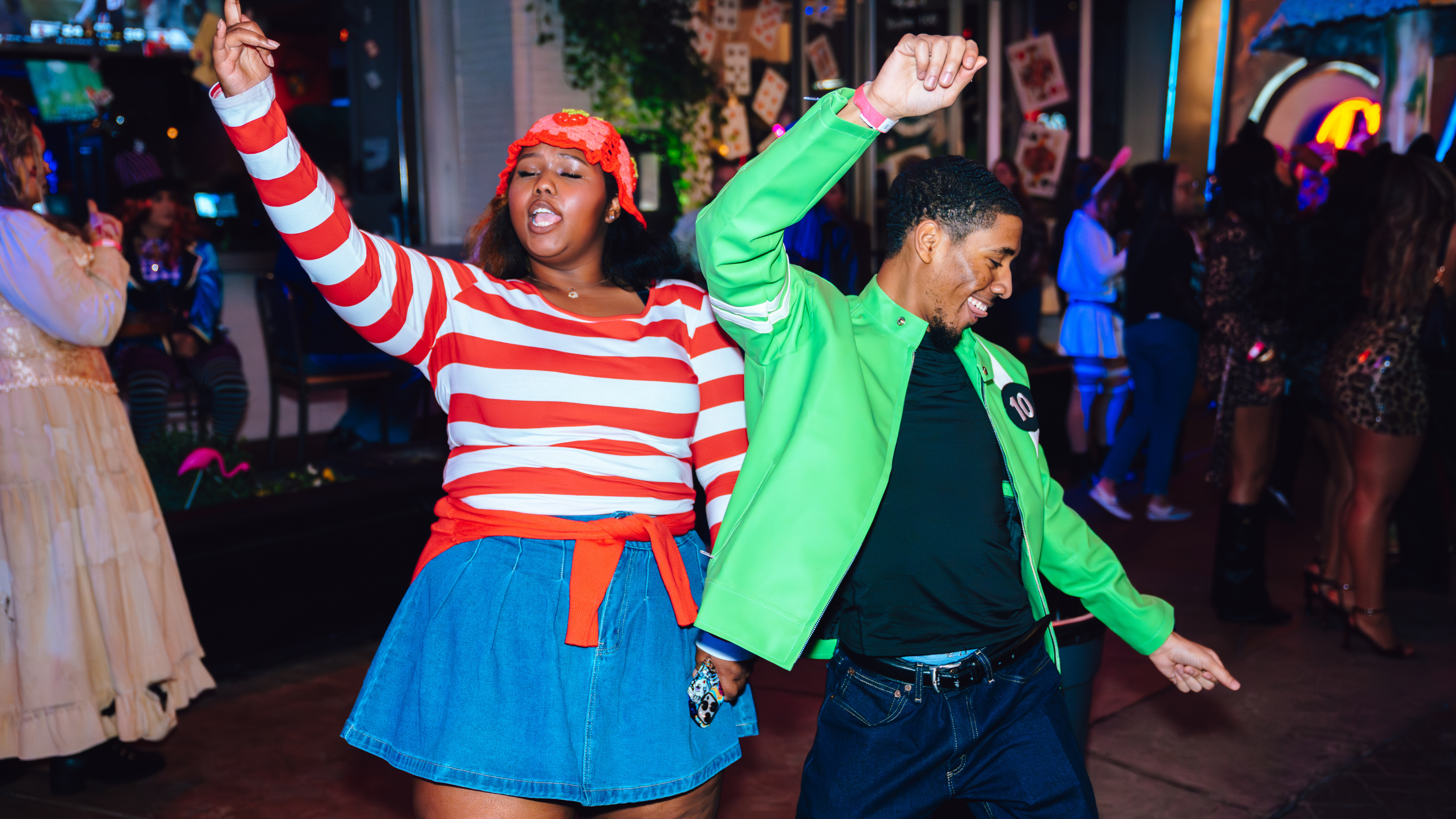 An image of a man and a woman dancing in Halloween costumes at a Halloween party.