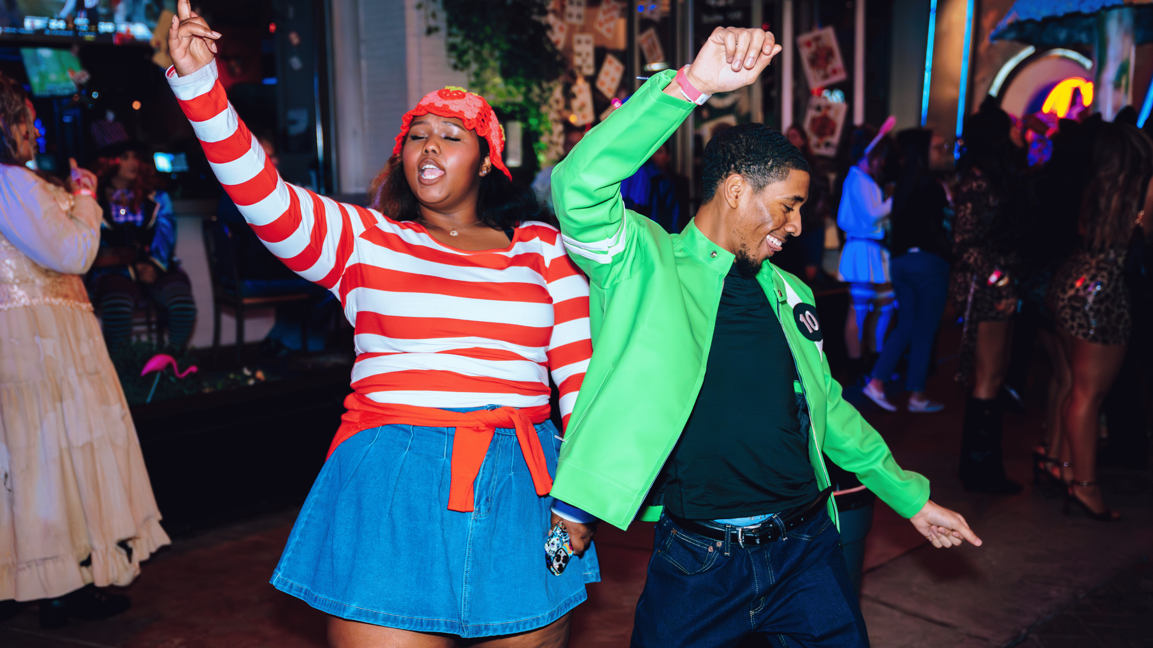 An image of a man and a woman dancing in Halloween costumes at a Halloween party.