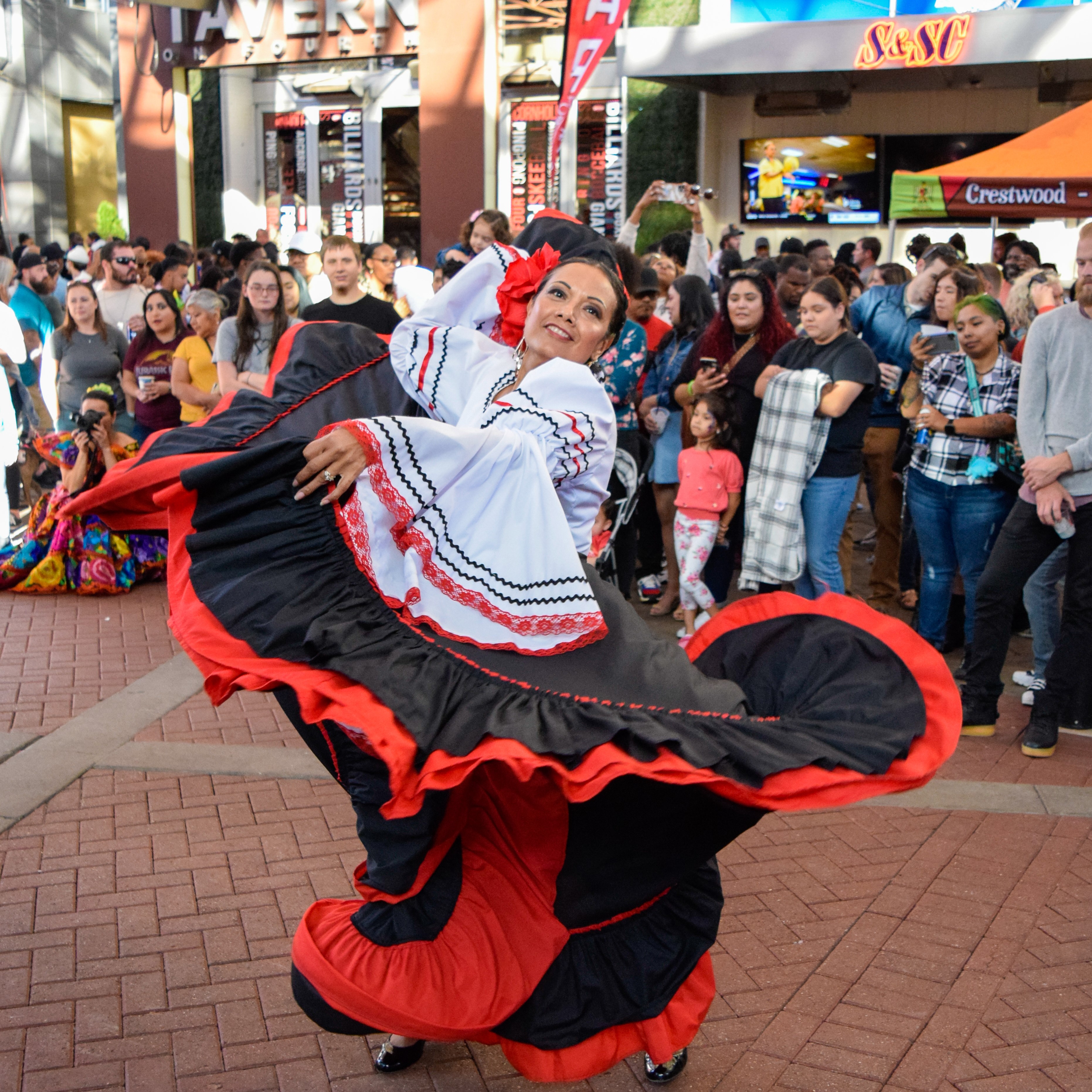 A woman dancing in front of a crowd.