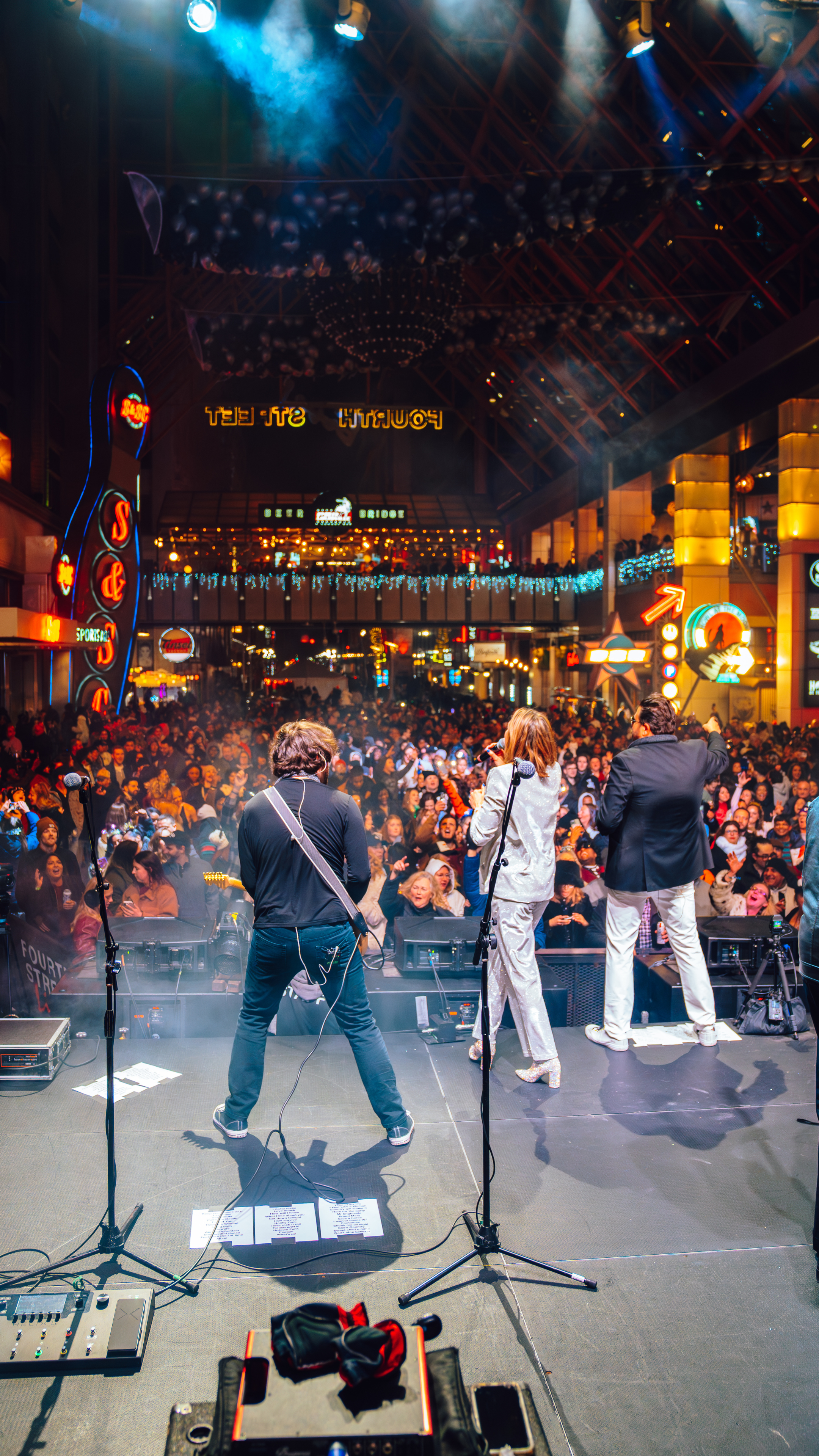 An image from behind the band playing on stage at an NYE party.