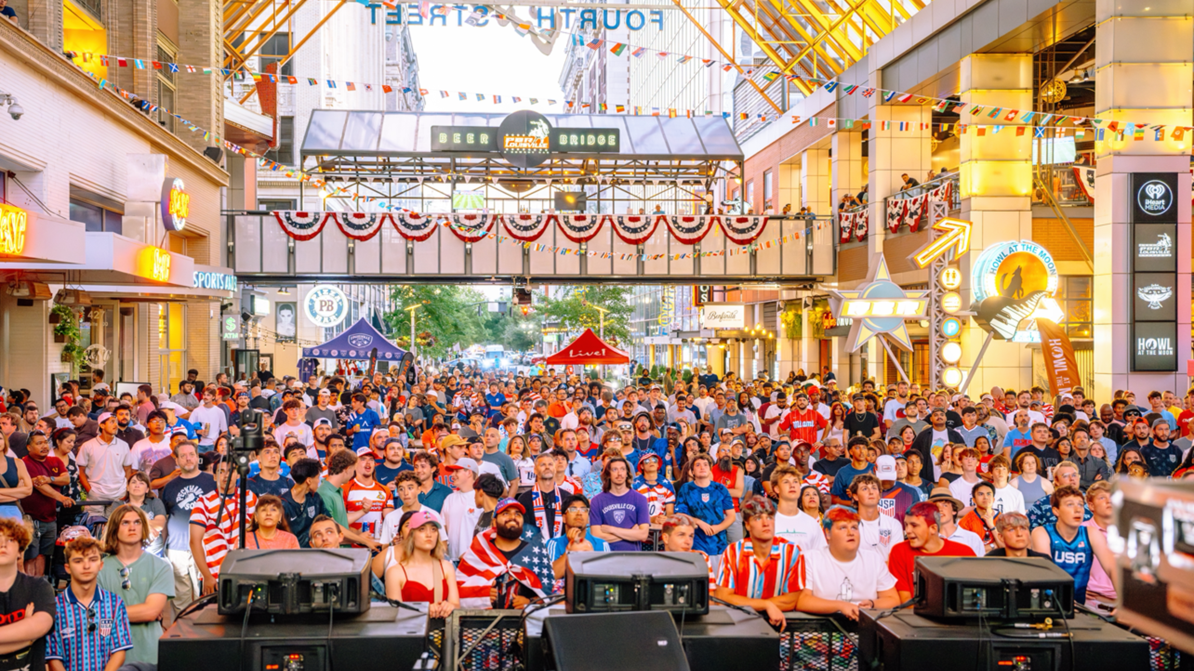 An image of hundreds of people in USA gear watching the World Cup game.