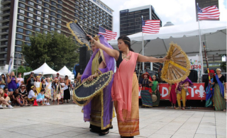 Cultura Philippines performing a dance with fans