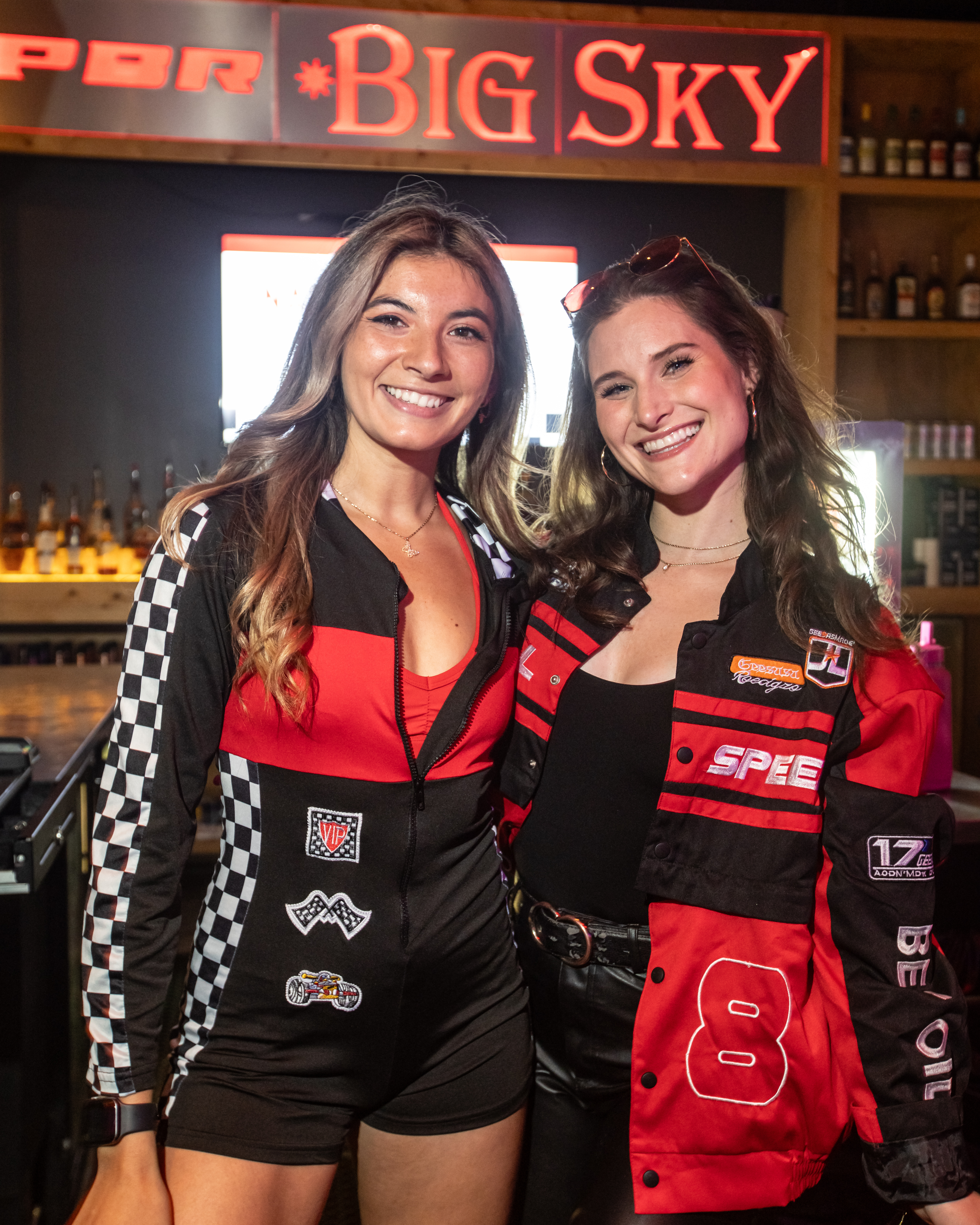 two pbr bartenders posing in racing wear costumes