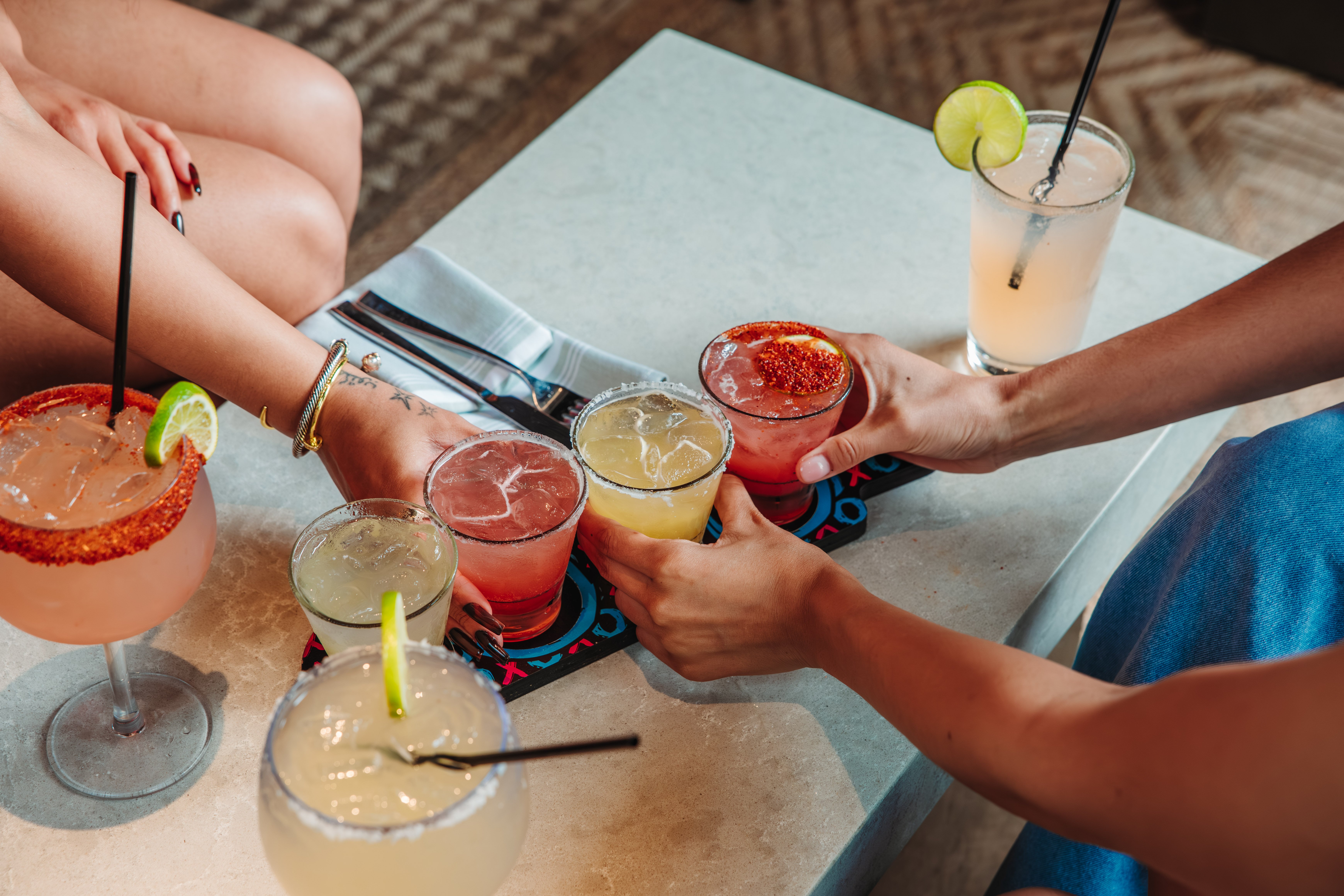 A margarita flight featuring lime and strawberry margs.
