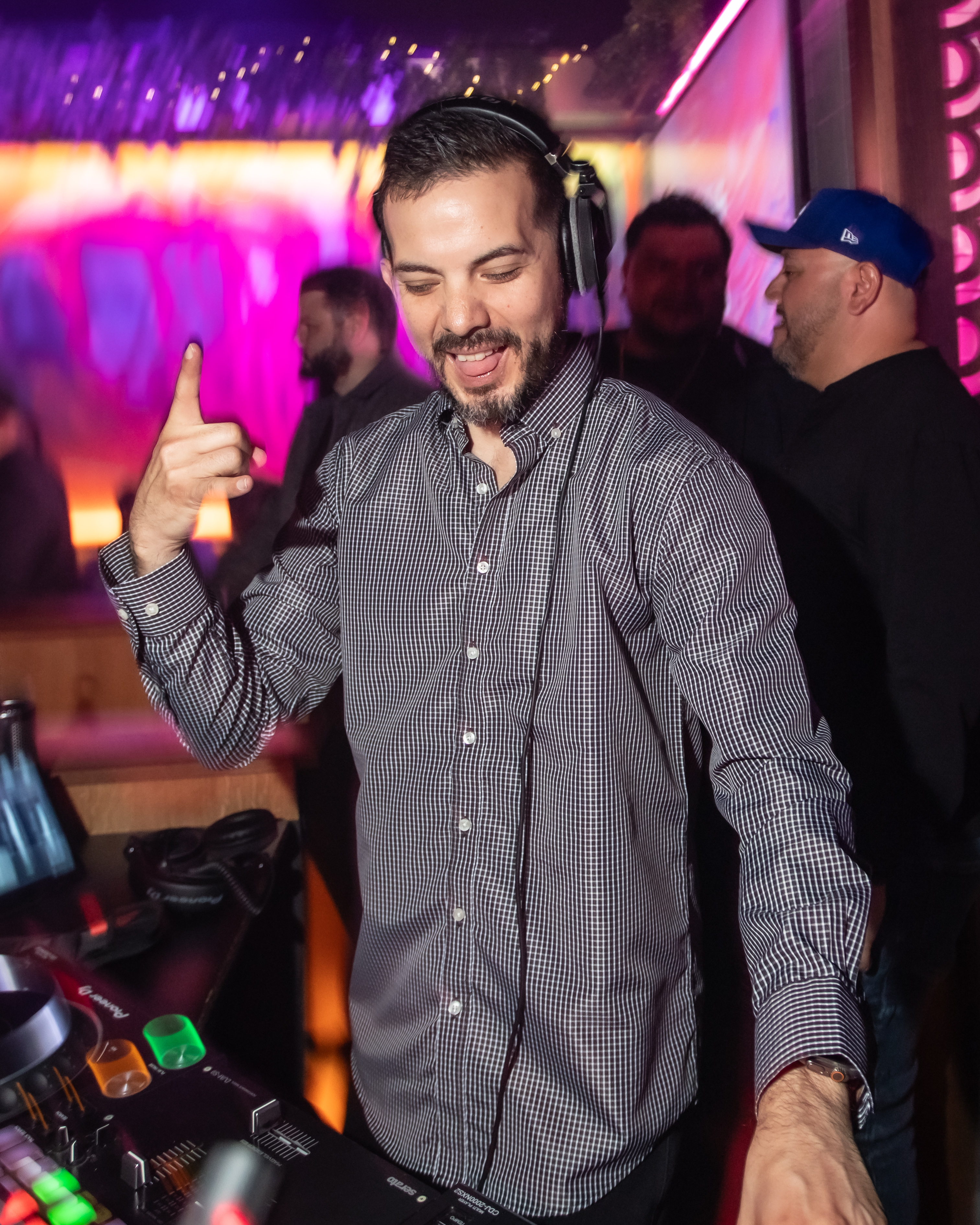 A DJ at Besos plays music behind the booth.