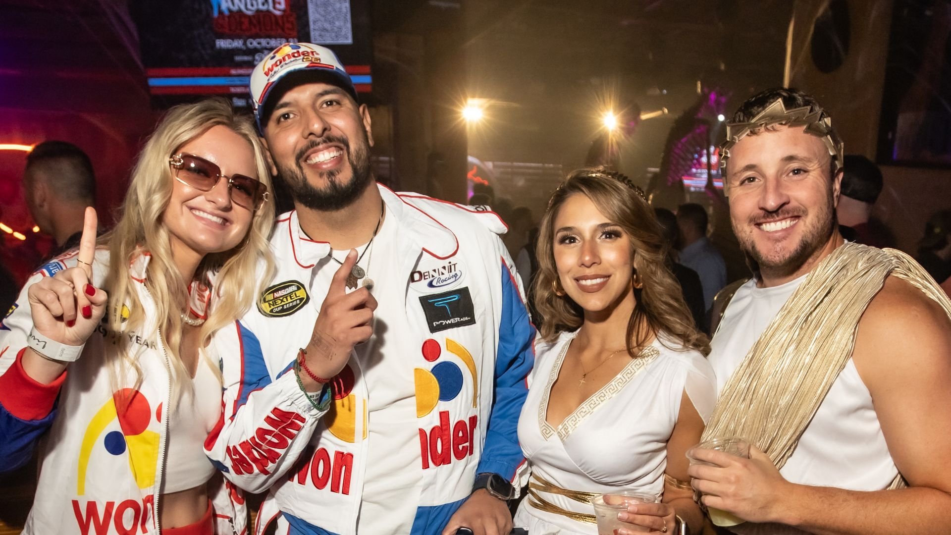 Guests wearing racing costumes and roman toga costumes at PBR Big Sky