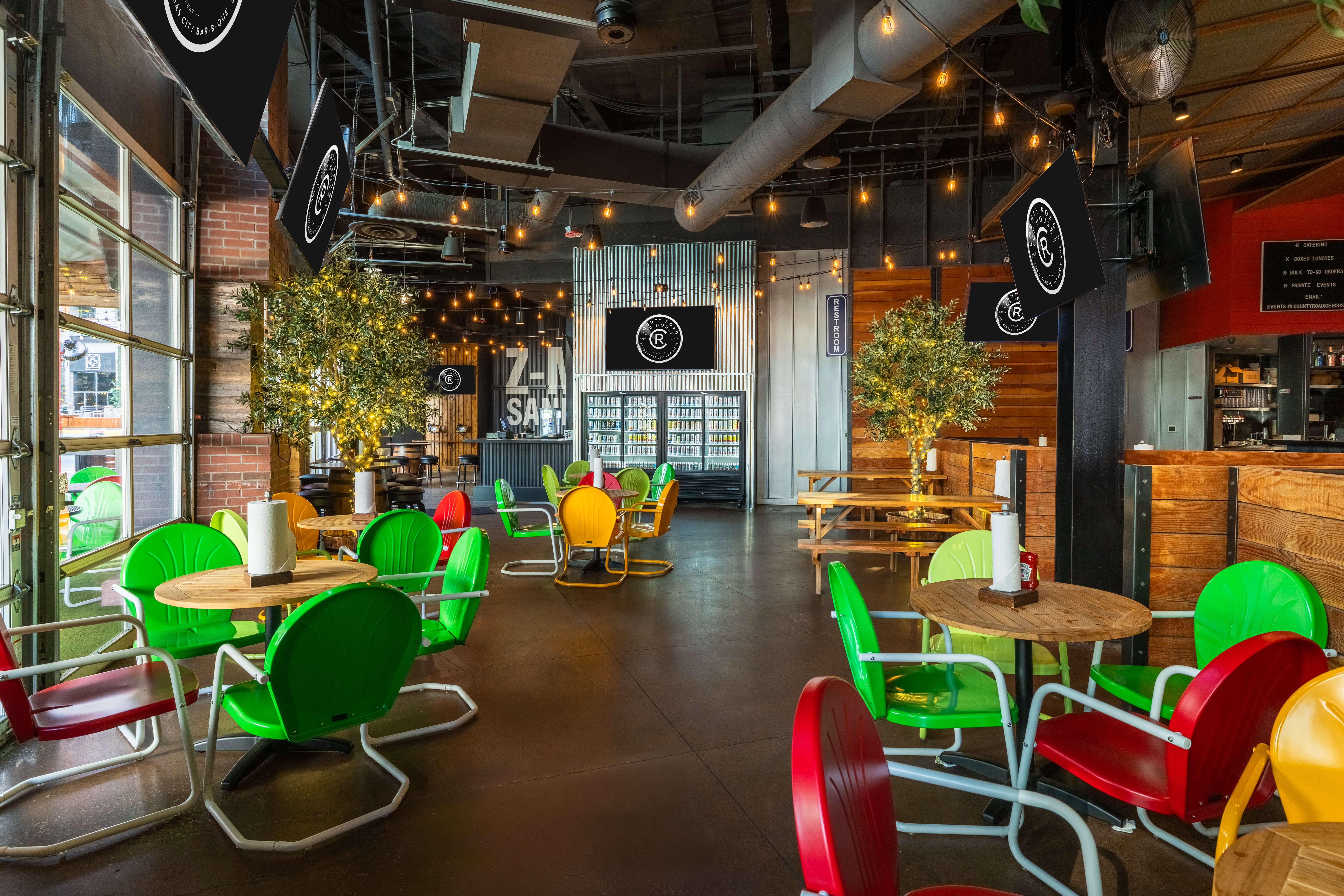 Indoor dining area of County Road with large tables and chairs.