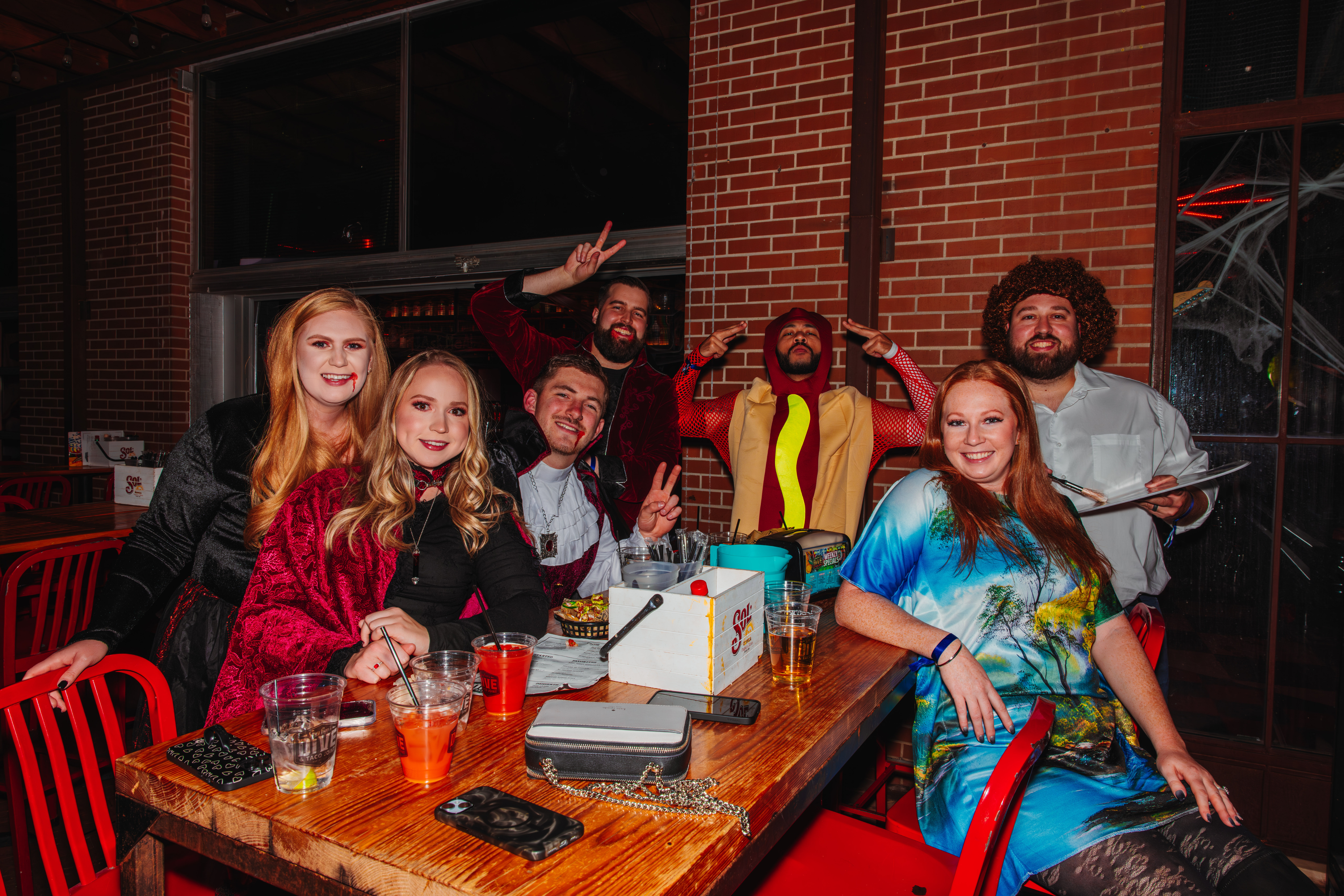 Guests on the patio at Guy Fieri's Dive and Taco Joint dressed in various Halloween Costumes