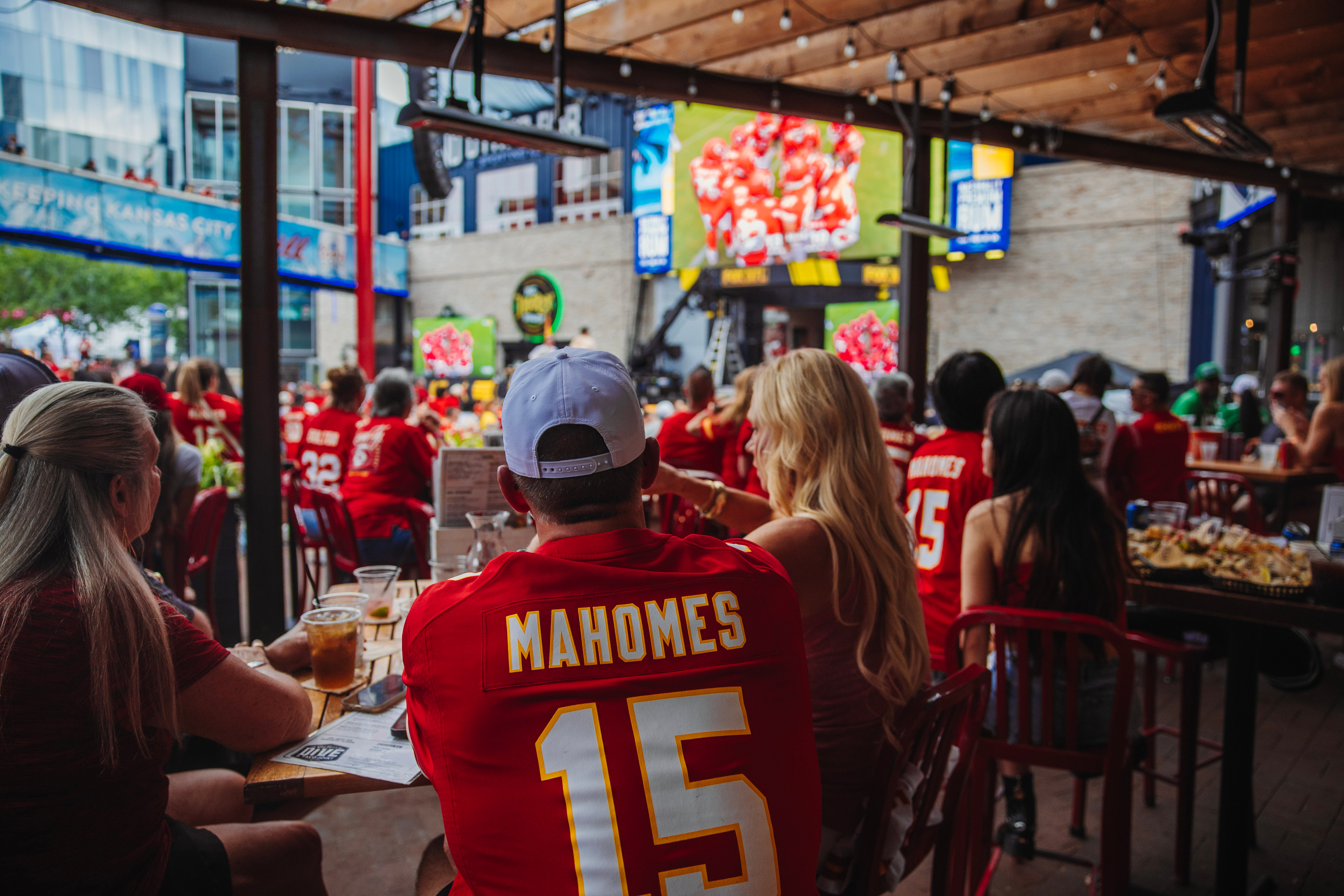 Fans watching the Kansas City Chiefs game from the patio at Guy Fieri's Dive and Taco Joint