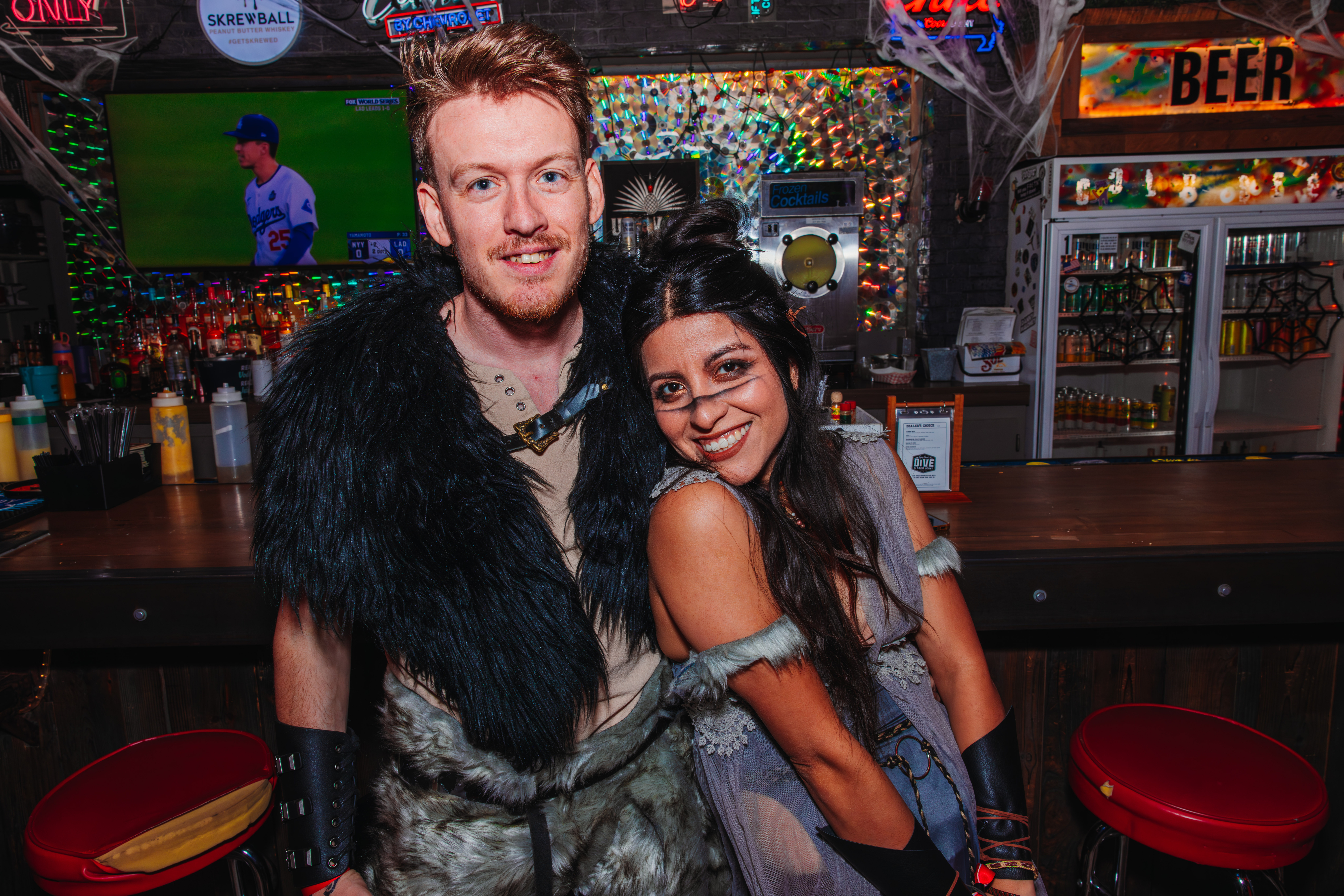 Male and female guests dressed in Halloween costumes at Guy Fieri's Dive and Taco Joint