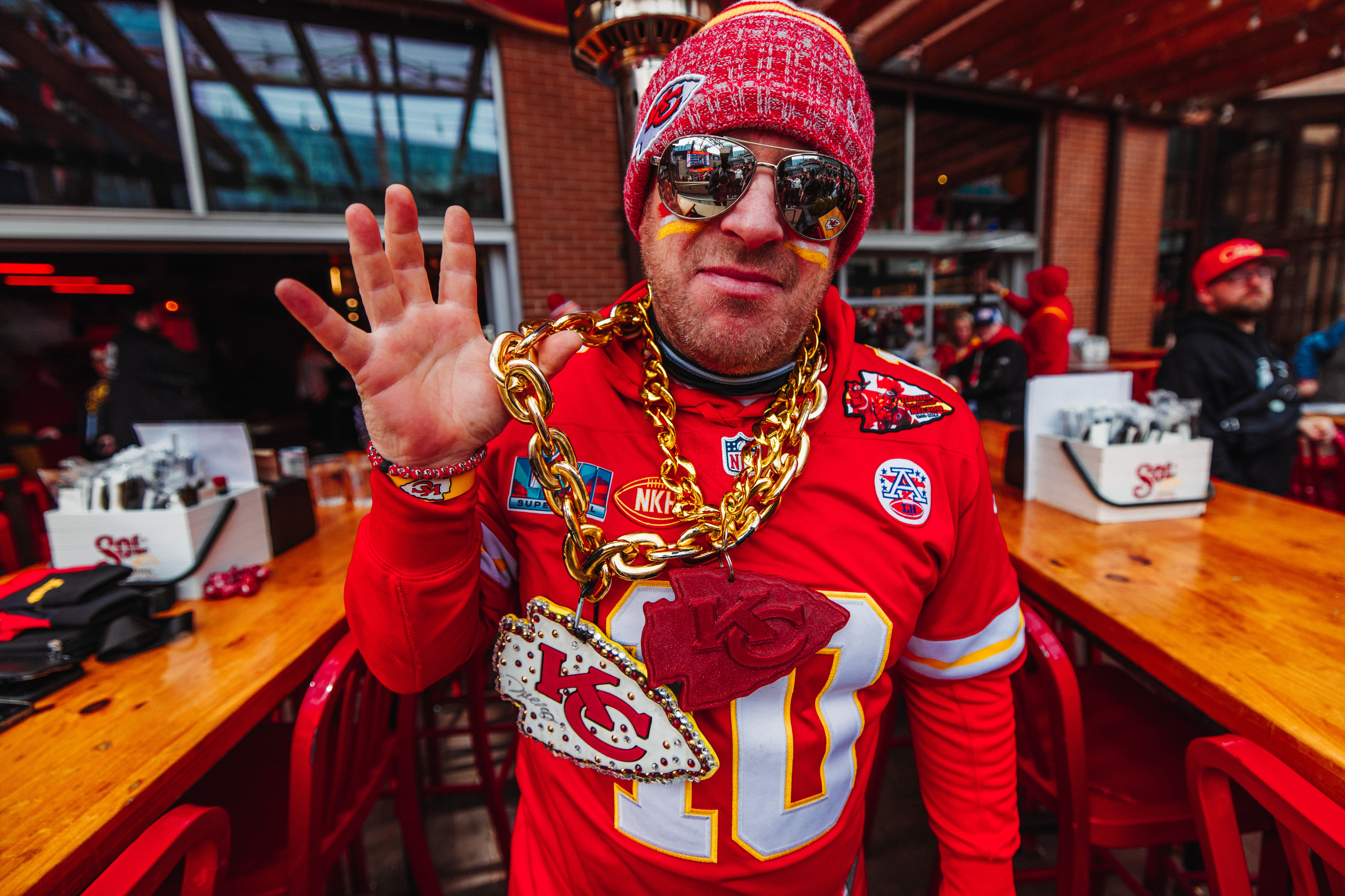 Man wearing Kansas City Chiefs merchandise on the patio at Guy Fieri's Dive and Taco Joint