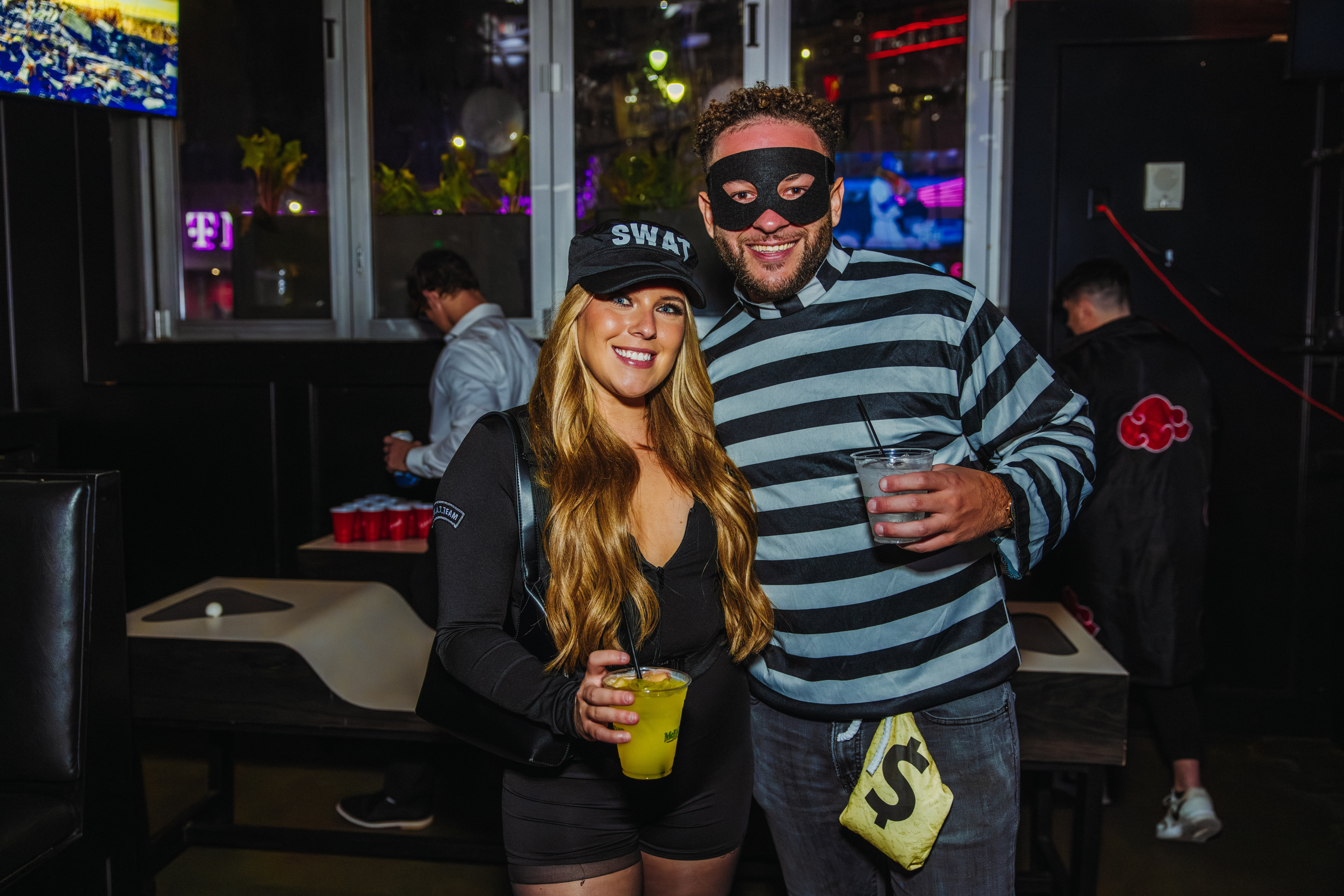Couple dressed as SWAT team member and a robber at McFadden's