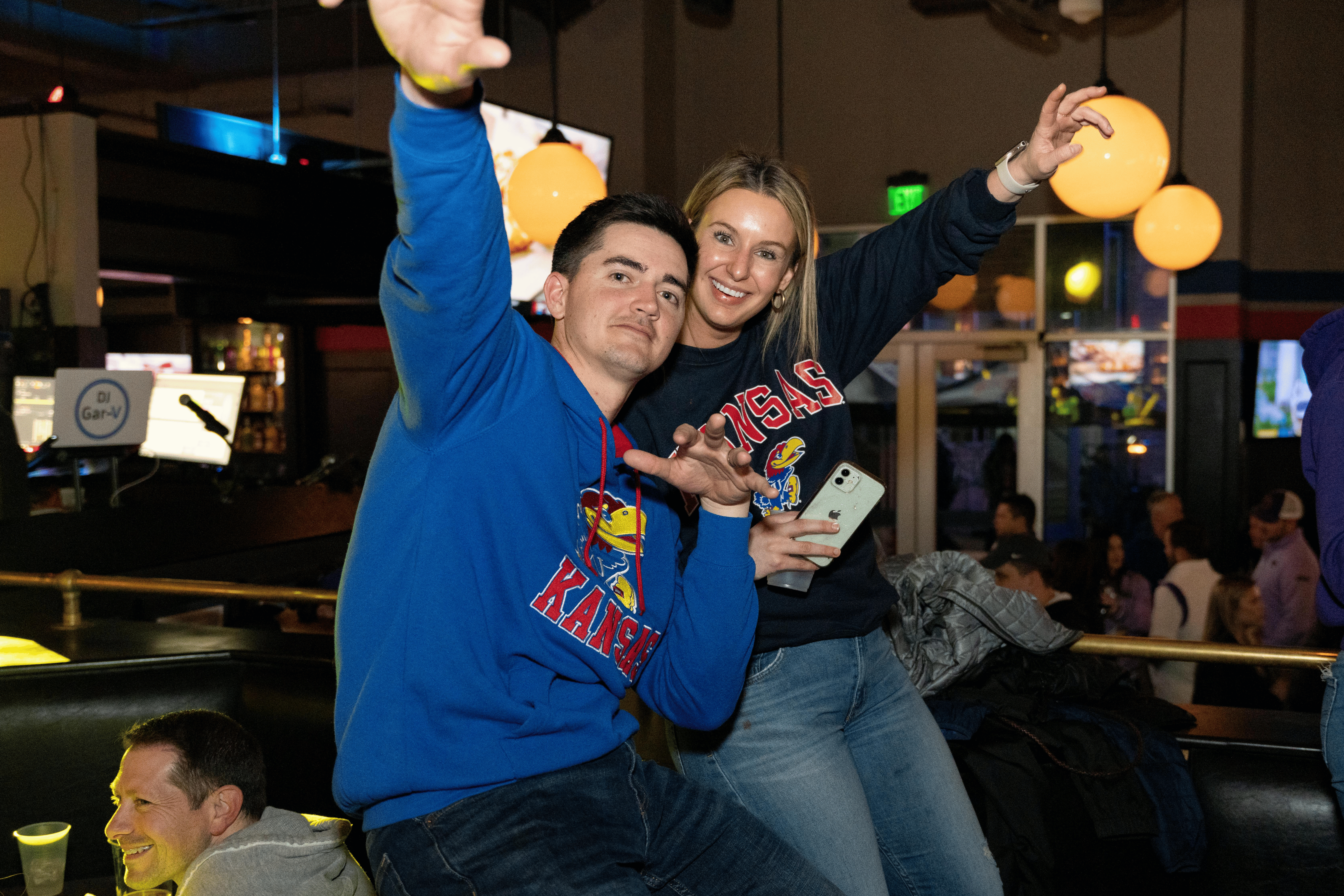 Two KU fans sitting in a booth