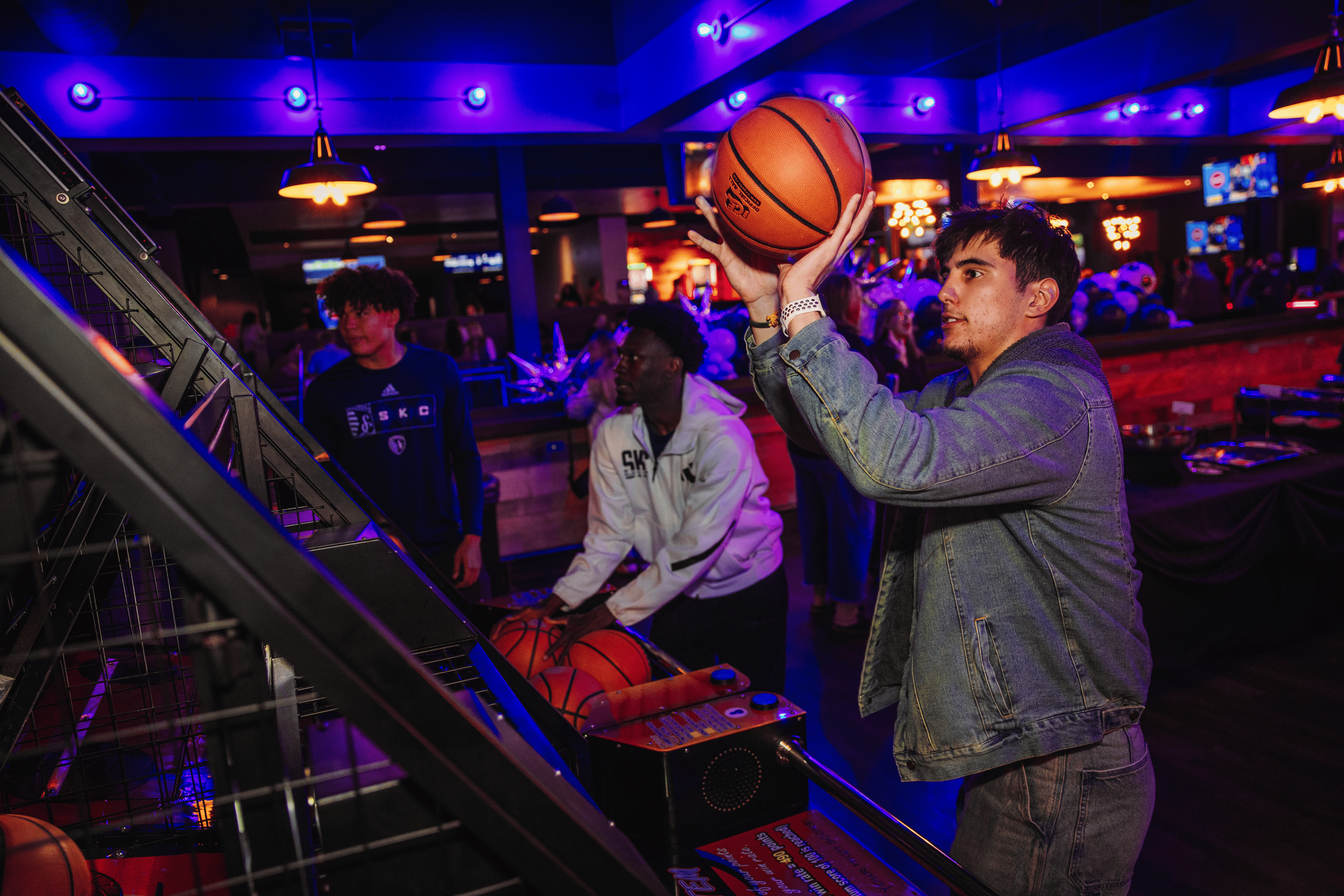 Two men playing basketball arcade game at No Other Pub