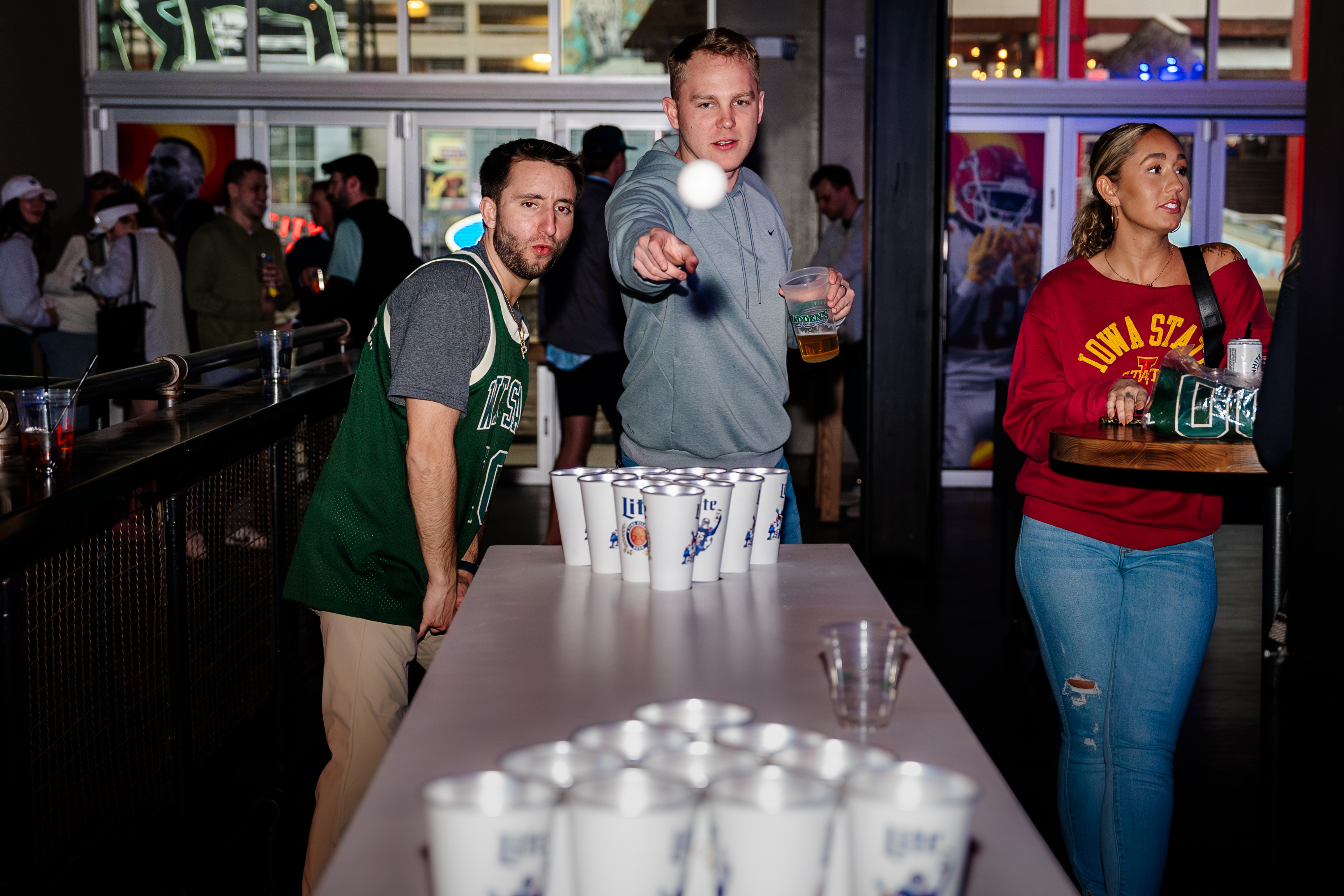 Two men playing beer pong at No Other Pub