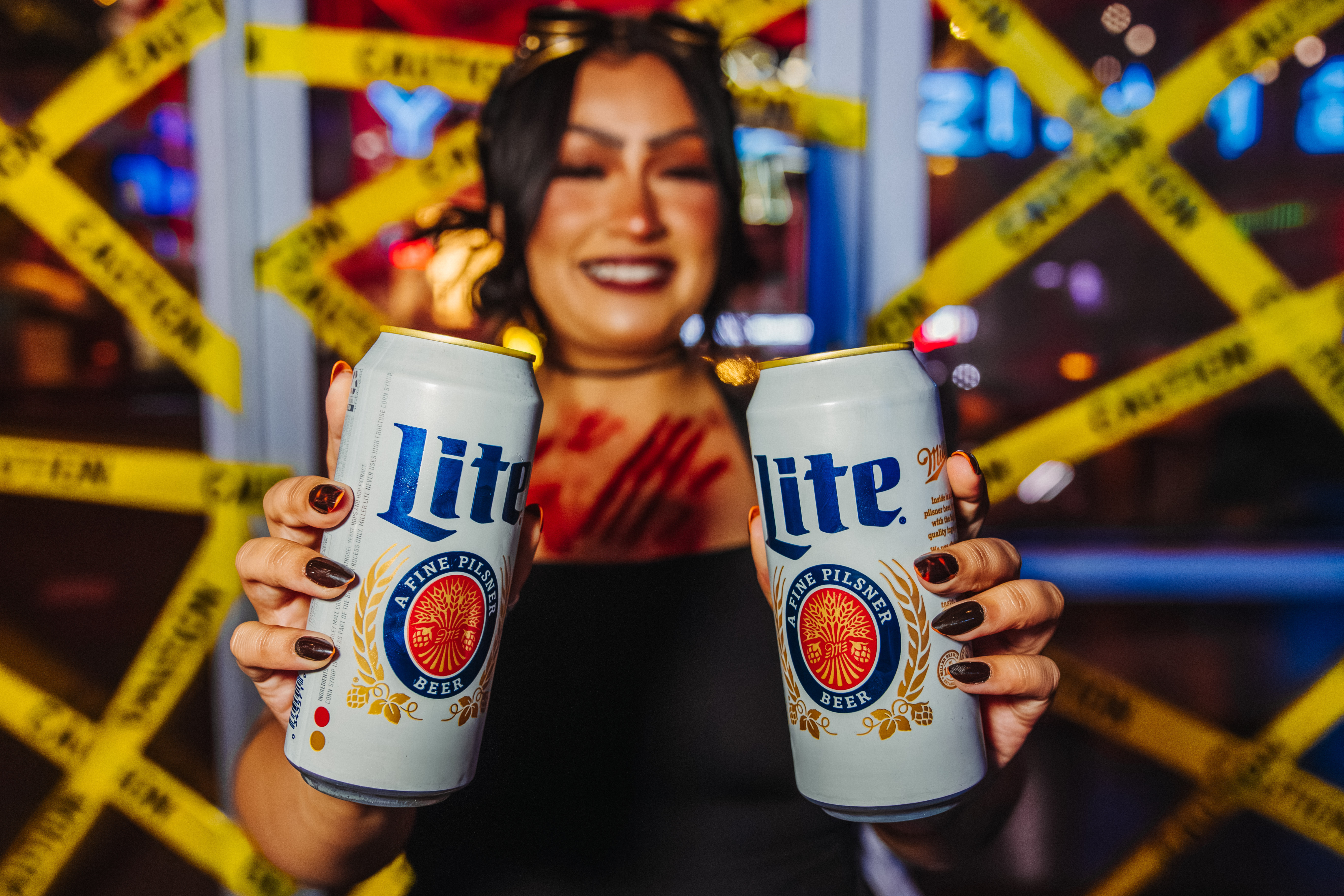 Bartender in Halloween costume holding two Miller Lite cans