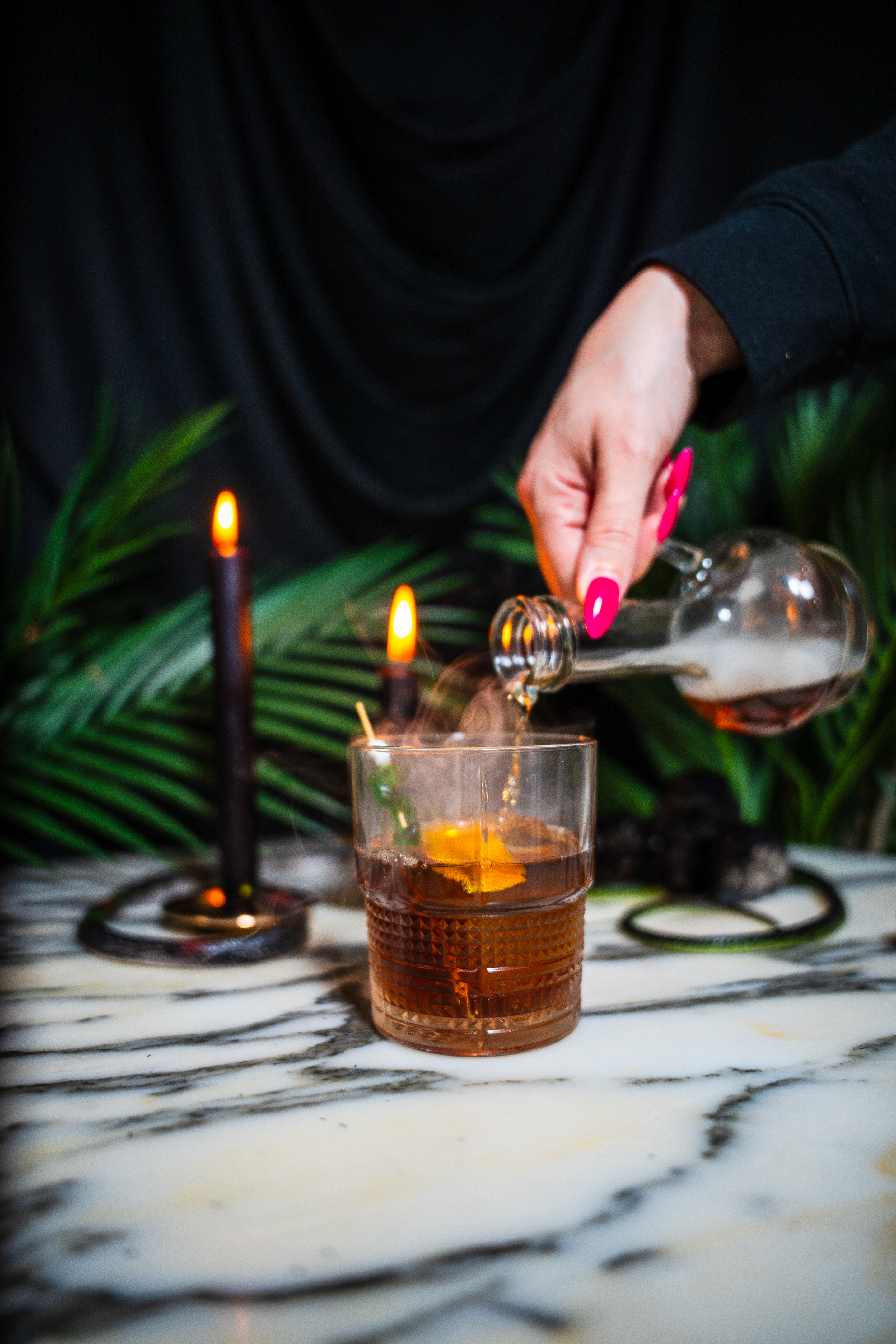 A spooky smoked old fashioned for Paradise Lost at Palm Tree on a marble table.