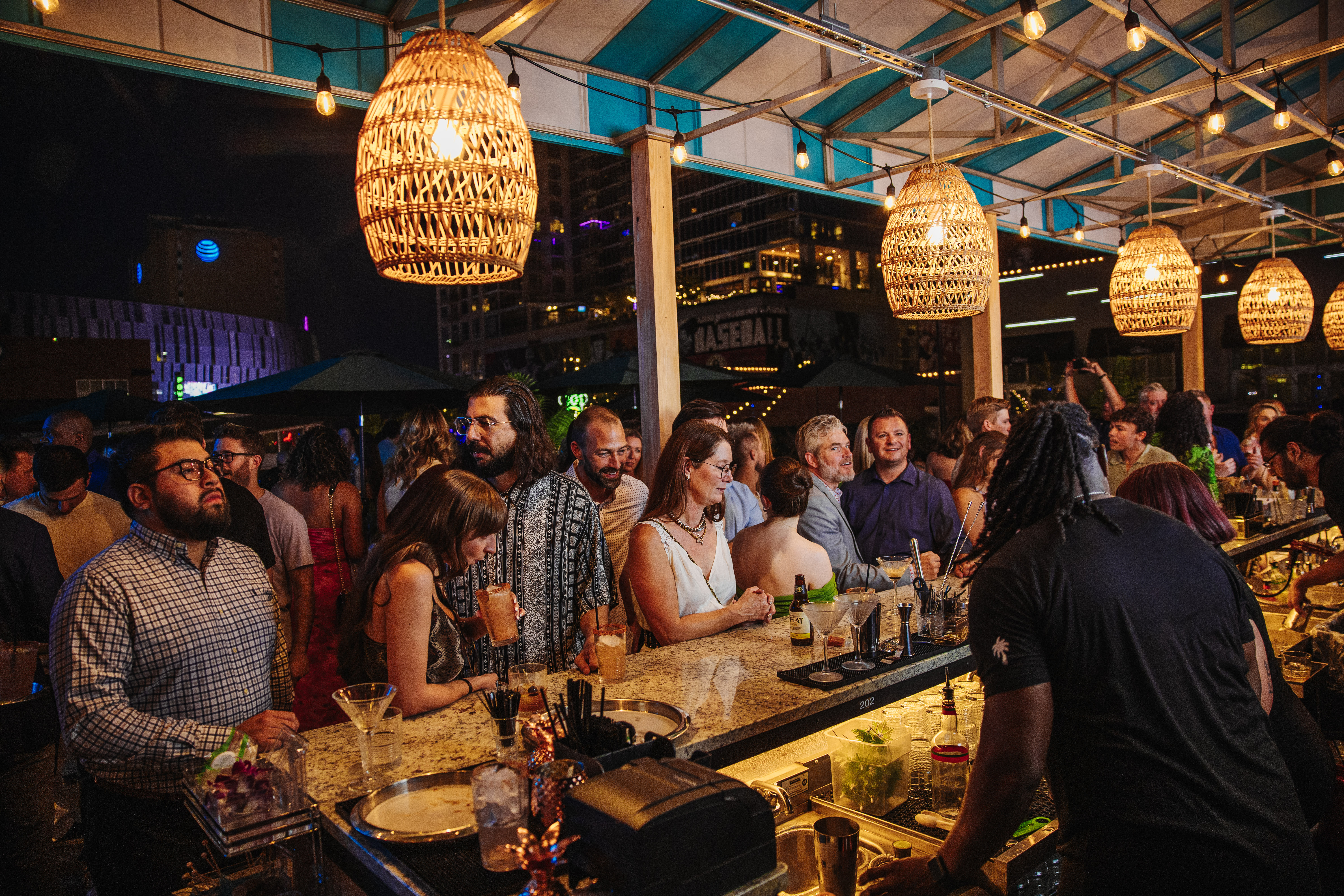 Guests enjoy global cocktails on the rooftop at Palm Tree KC.