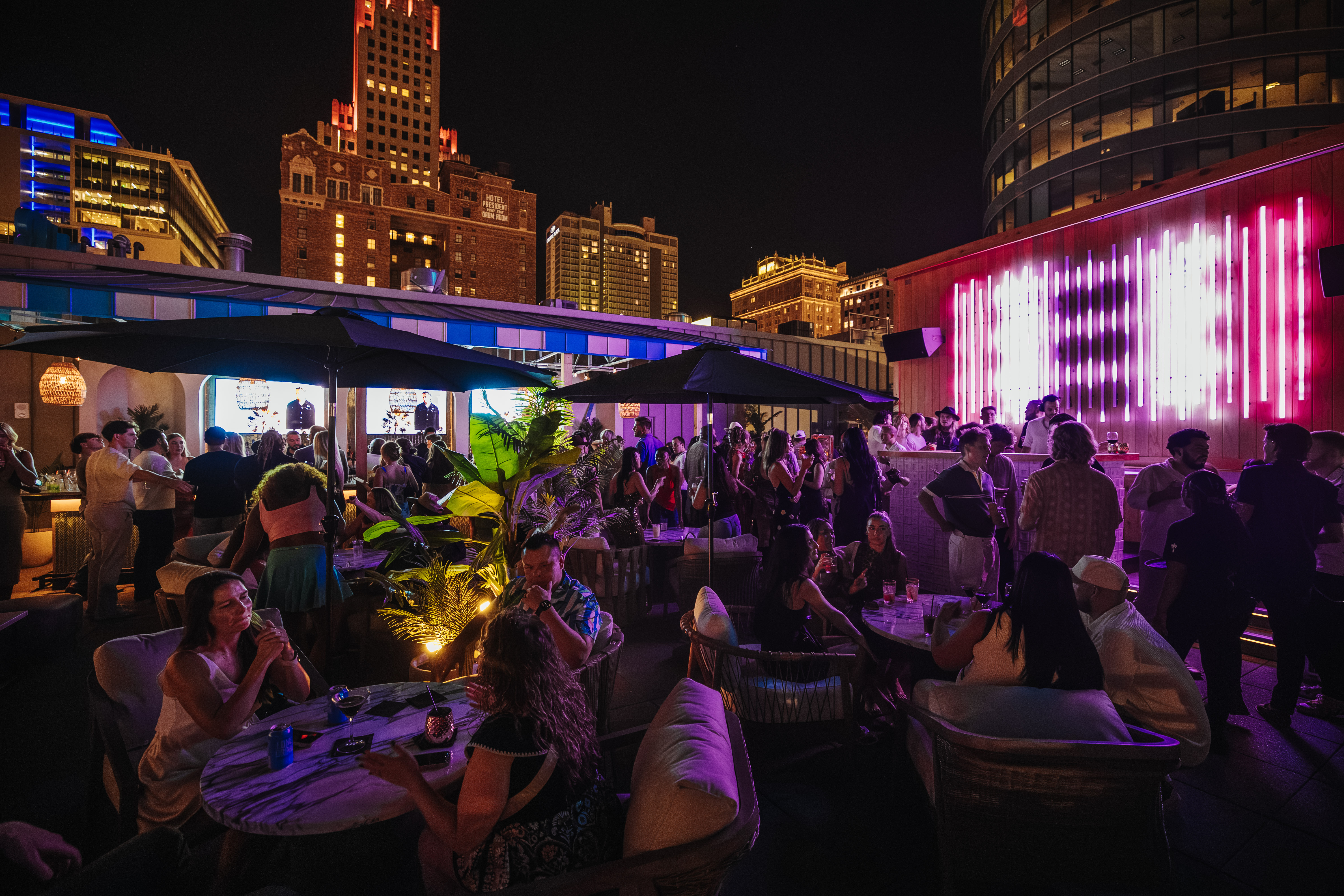 Guests enjoy curated sounds on the rooftop at Palm Tree KC.