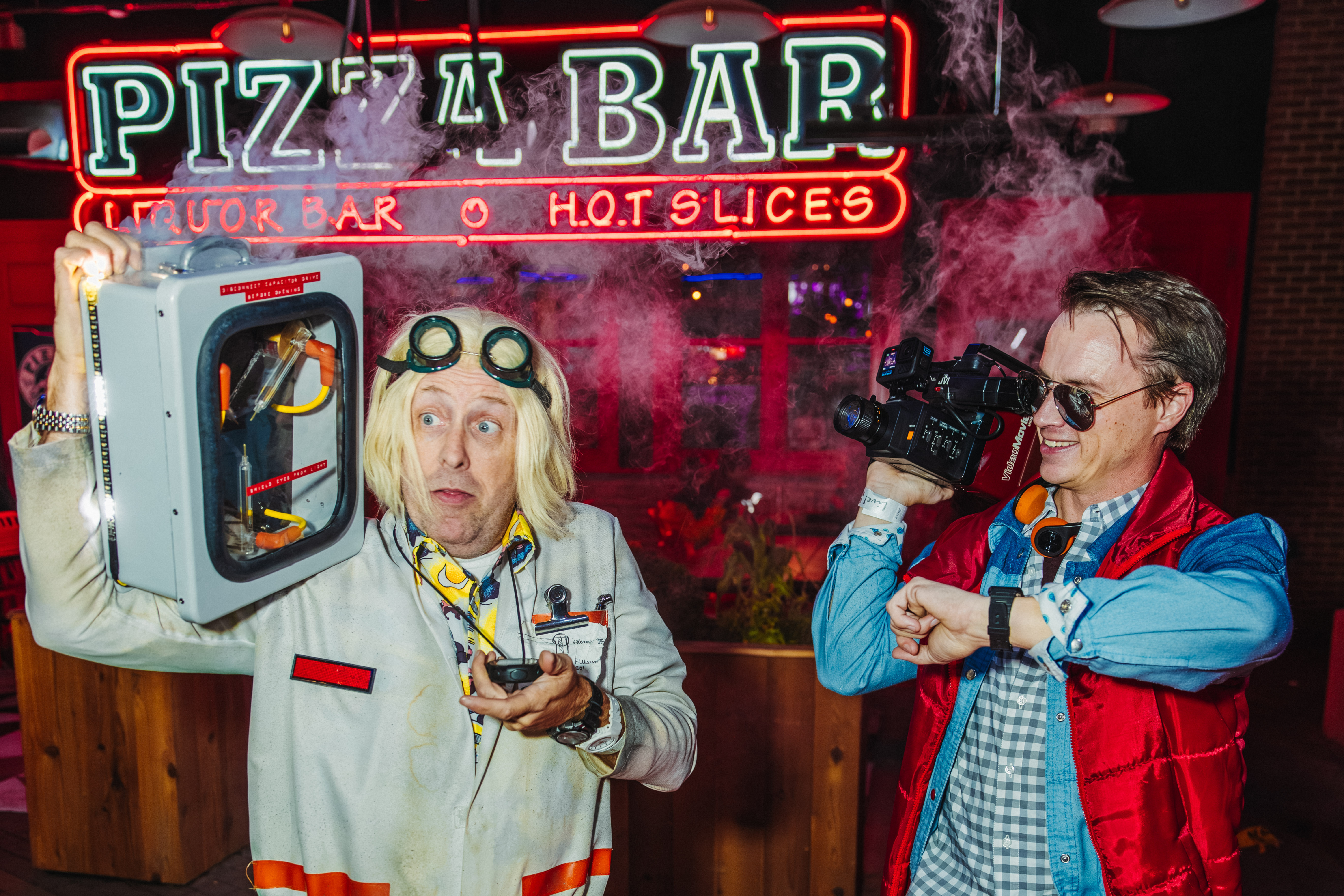 Two men in Halloween costumes outside of Pizza Bar