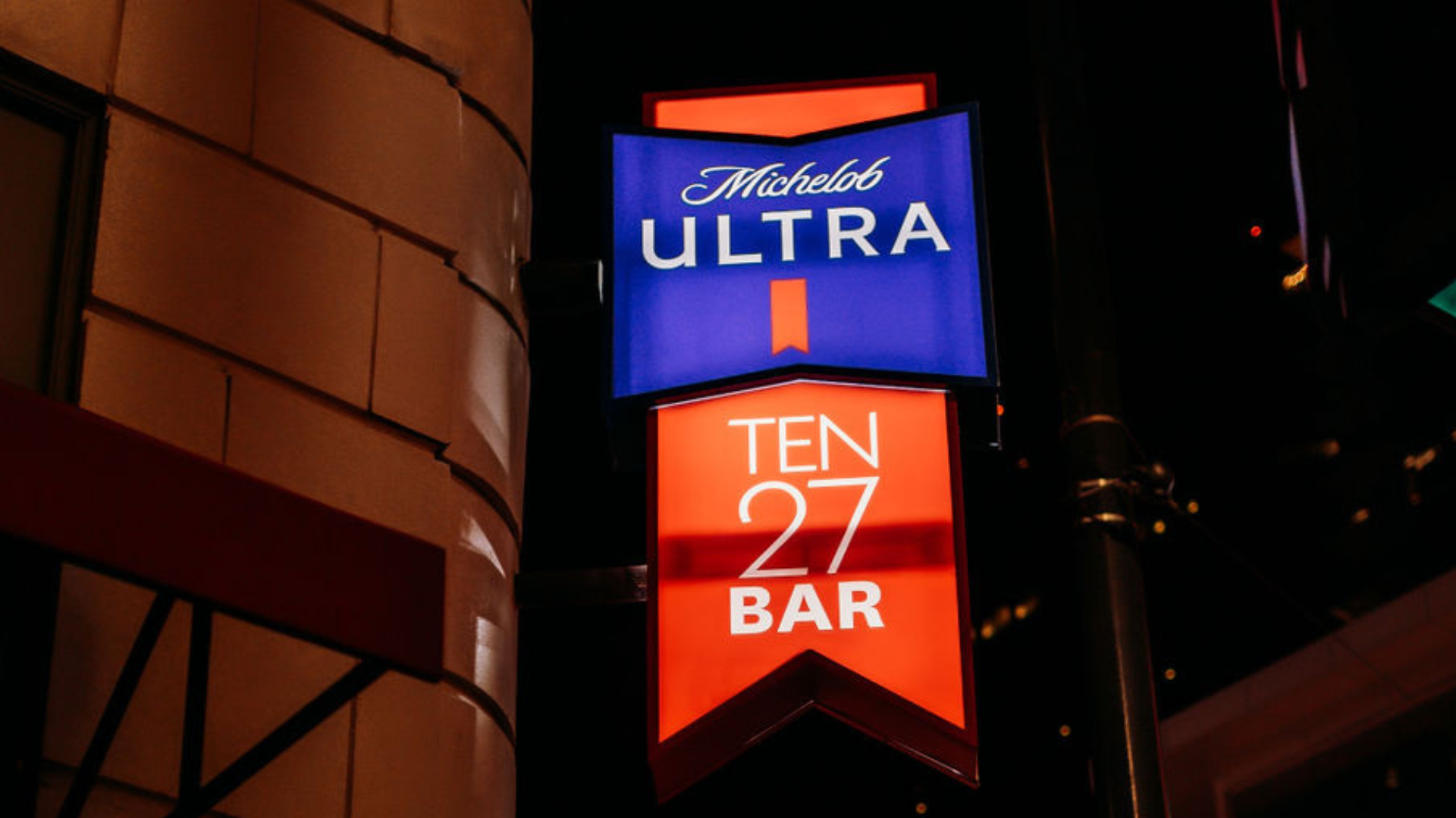 Ten 27 Bar exterior sign at night.