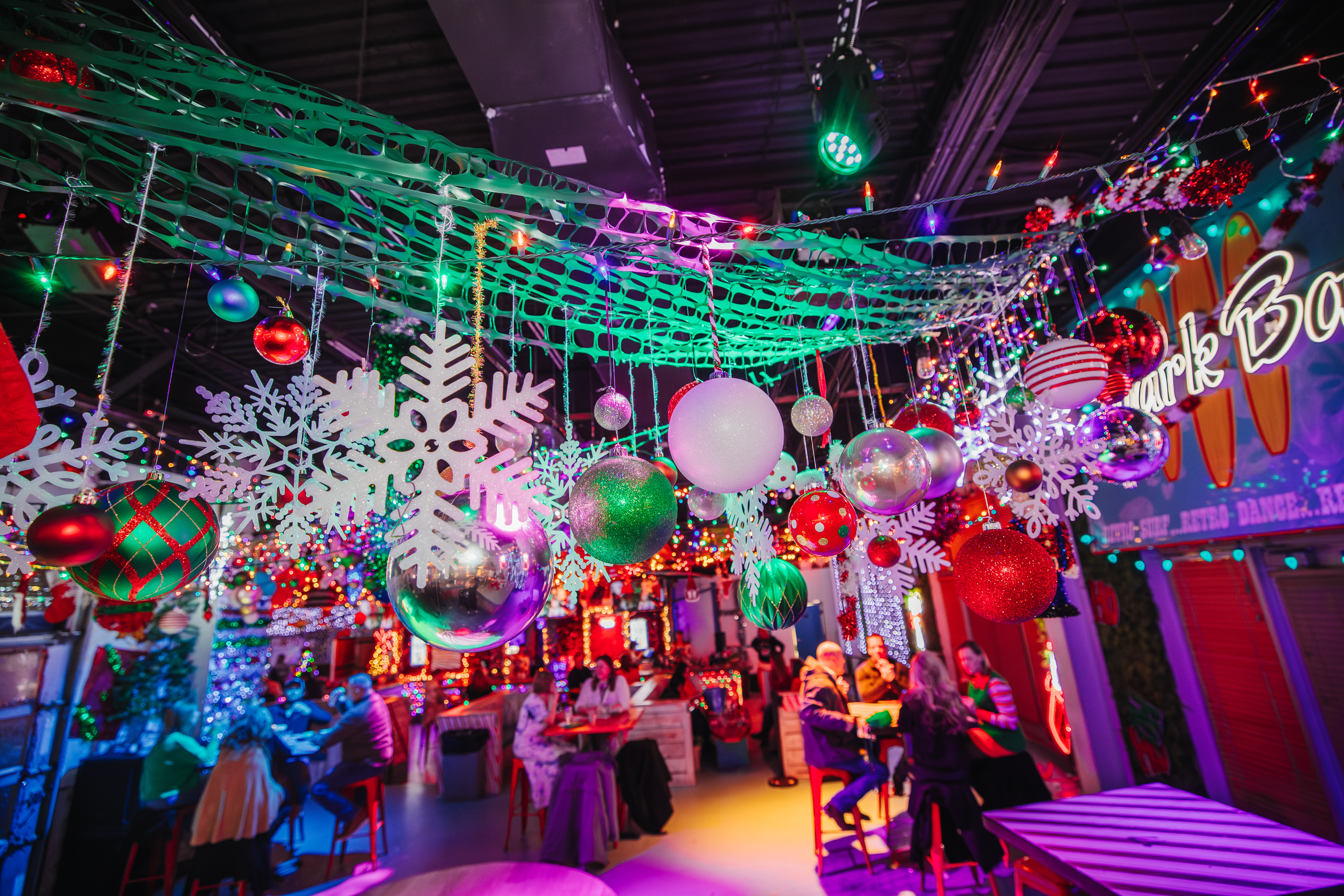 Holiday venue, Tinsel Tavern at KC Live!, decorated with large snowflakes, ornaments, garlands, lights and other colorful items.