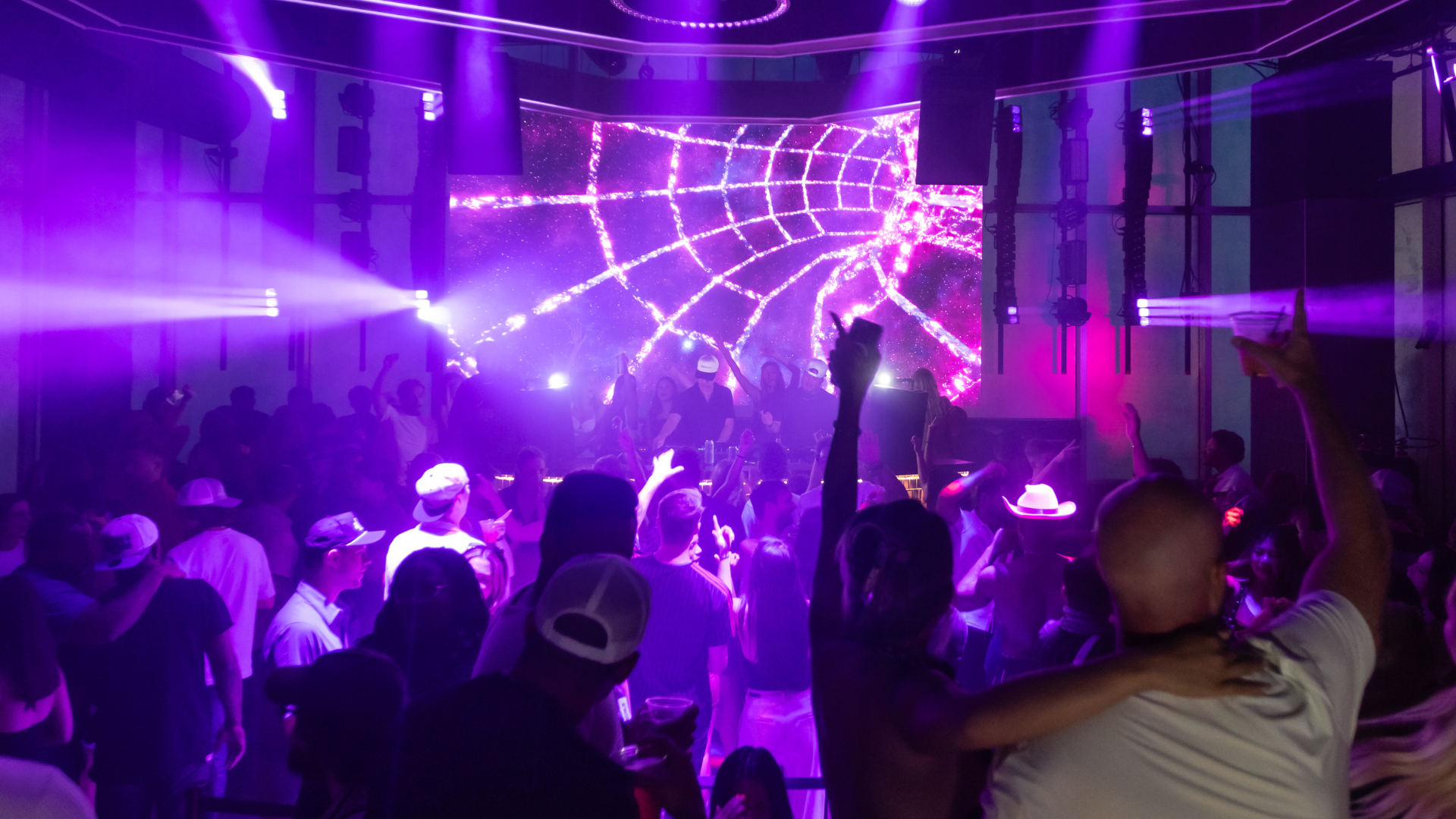 Mosaic nightclub with full crowd and purple ambient lighting