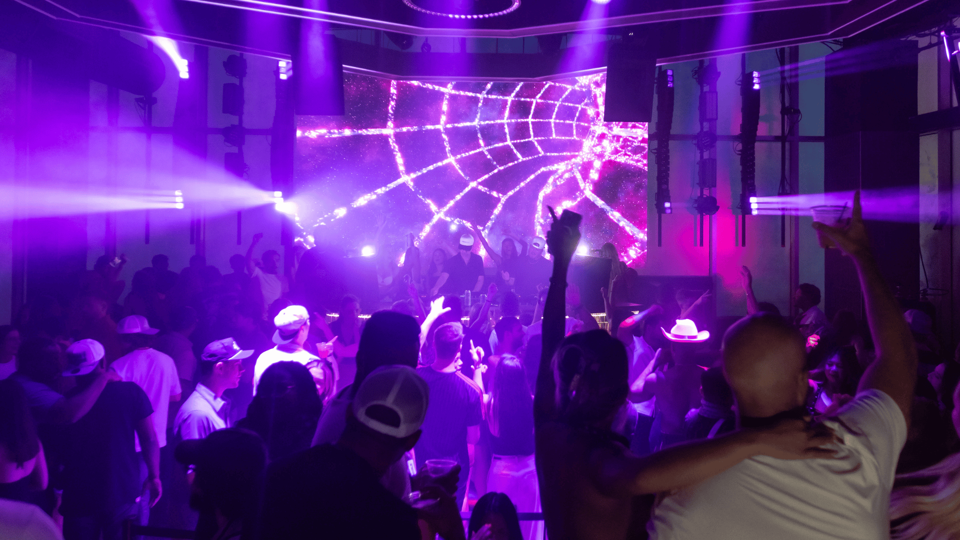 Mosaic nightclub with full crowd and purple ambient lighting