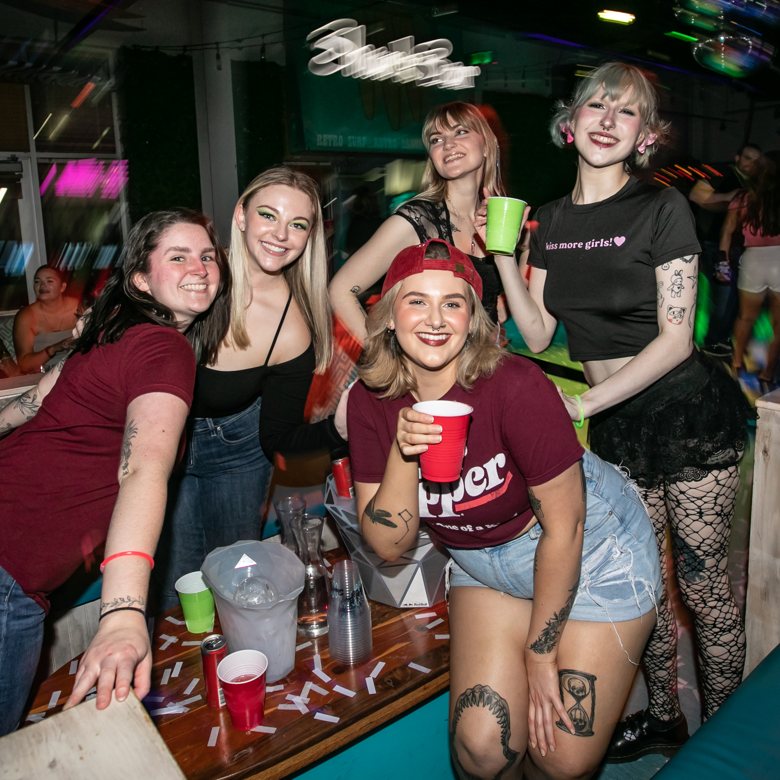 Guests wearing red and green shirts in VIP at our Stoplight Party