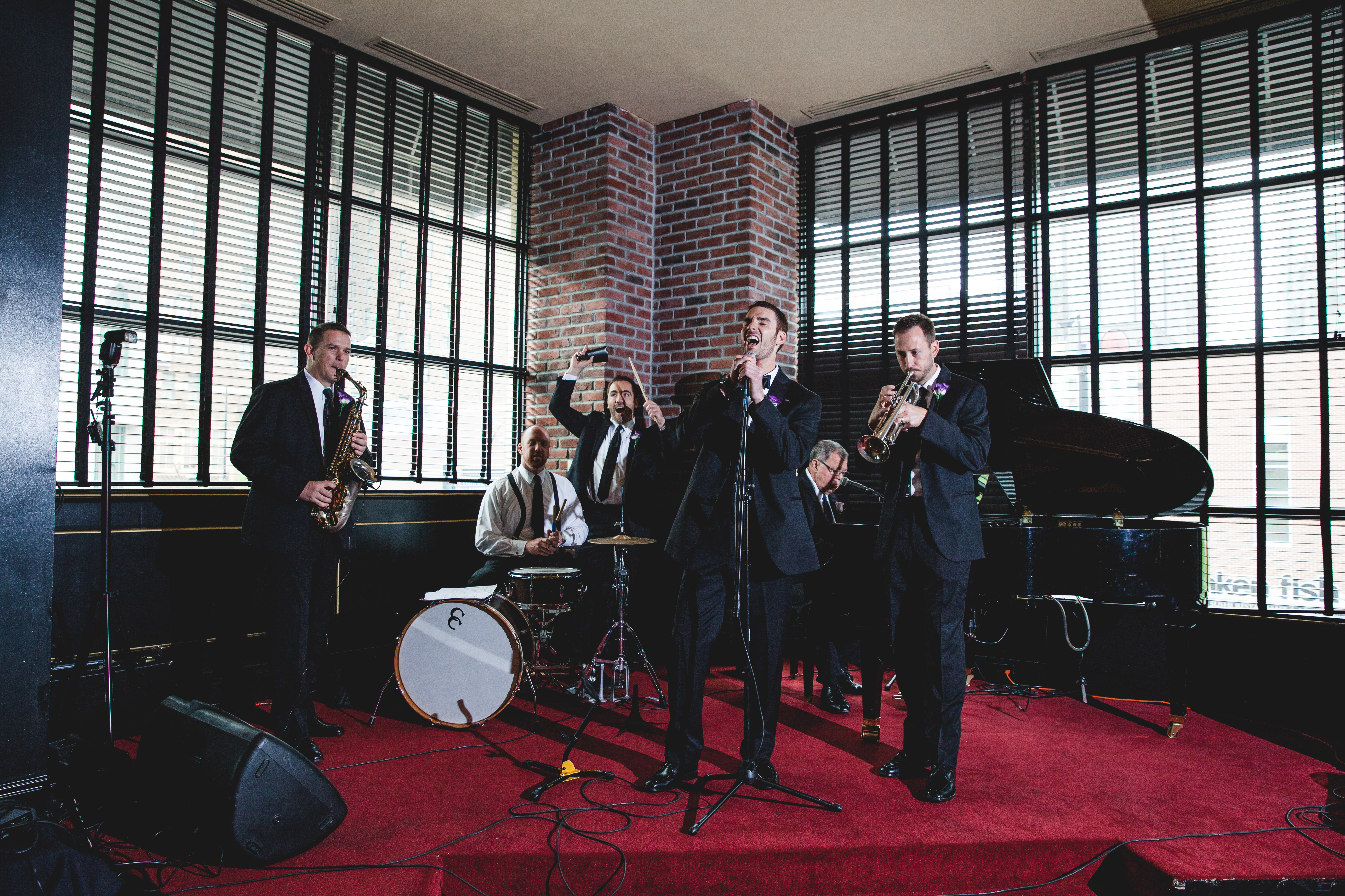 A four-piece jazz band playing on KDC's red stage.