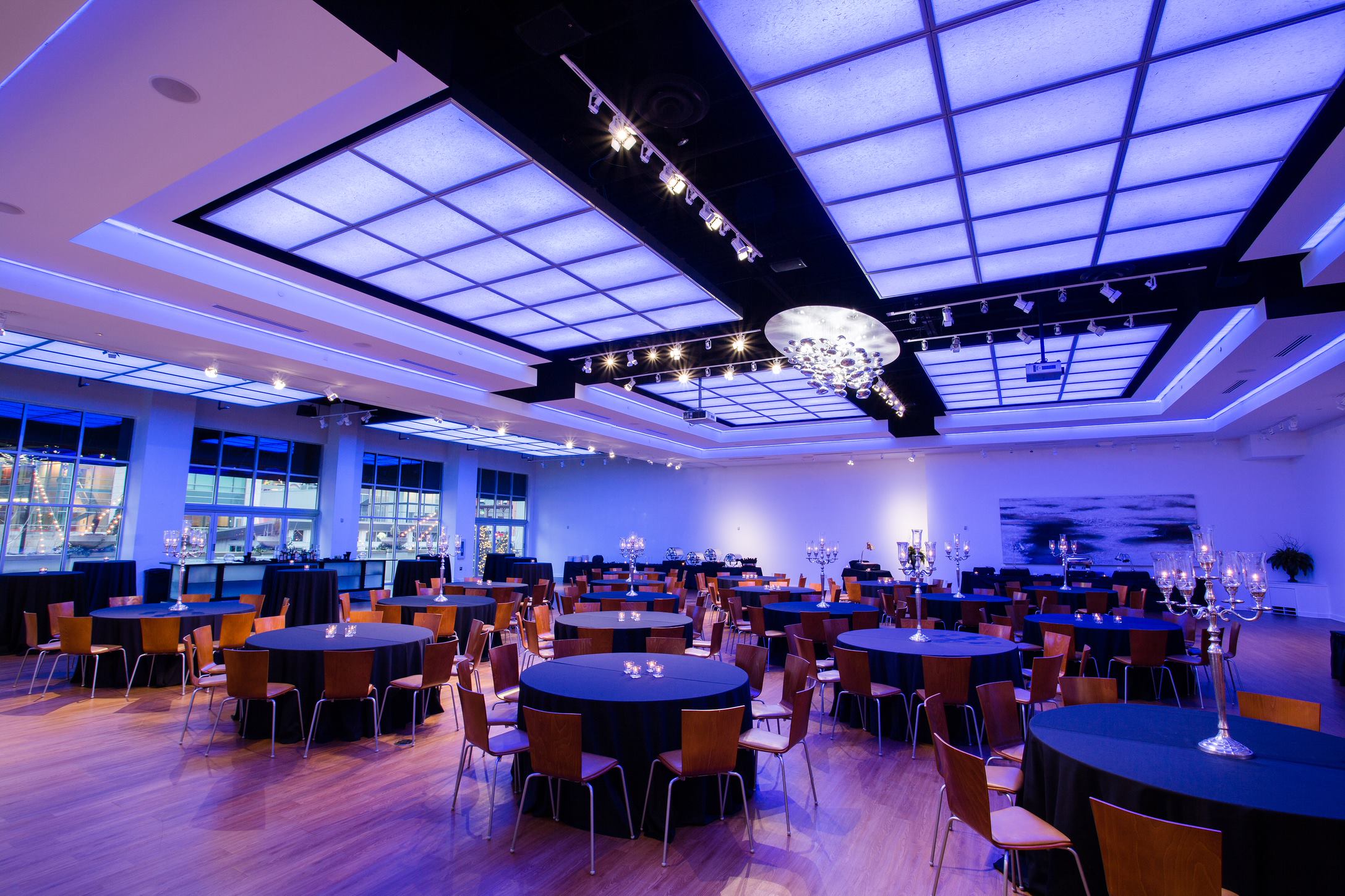 The Gallery interior set up with tables and custom blue lighting for corporate event.