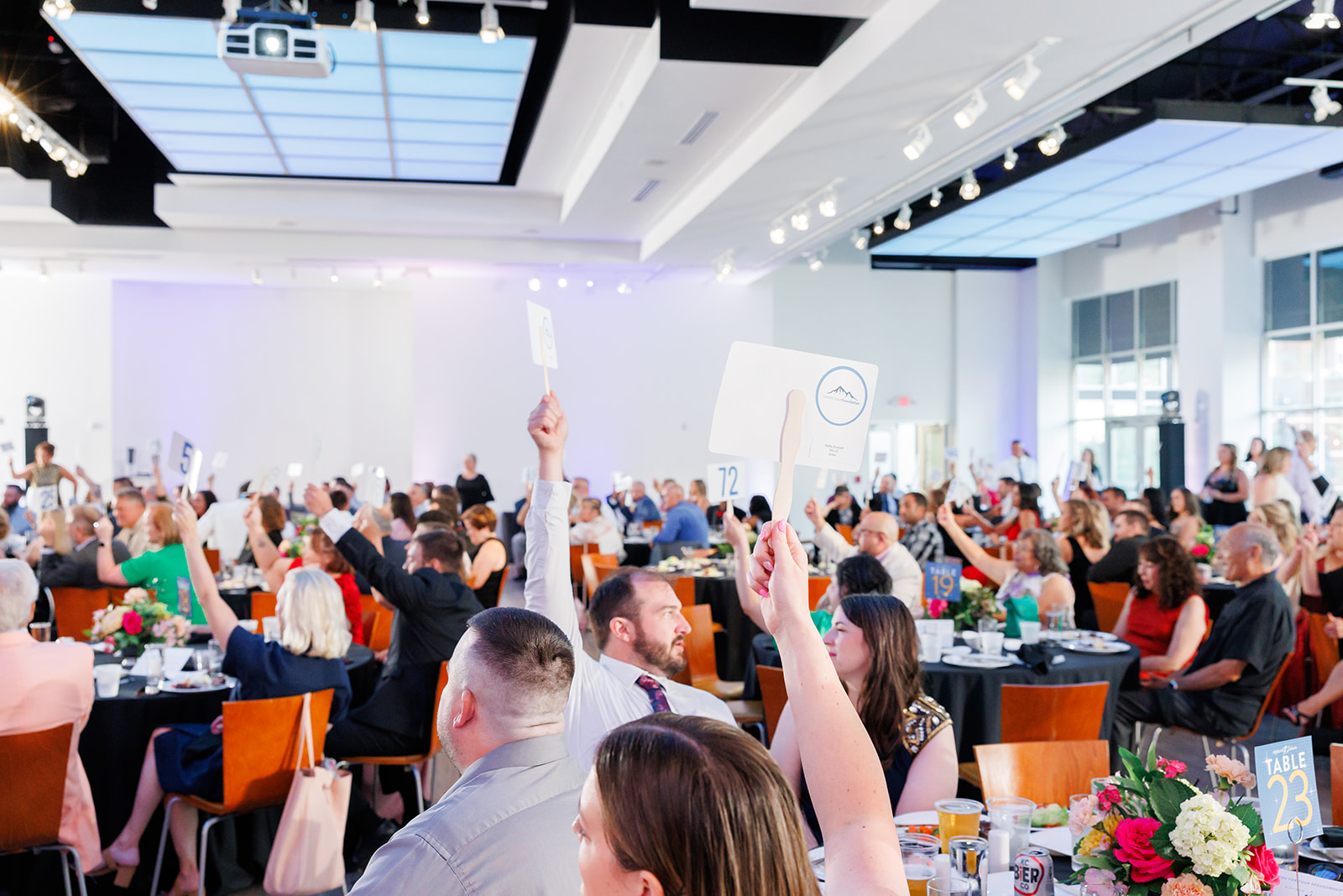The Gallery set with tables and chairs as guests participate in an engaging activity.