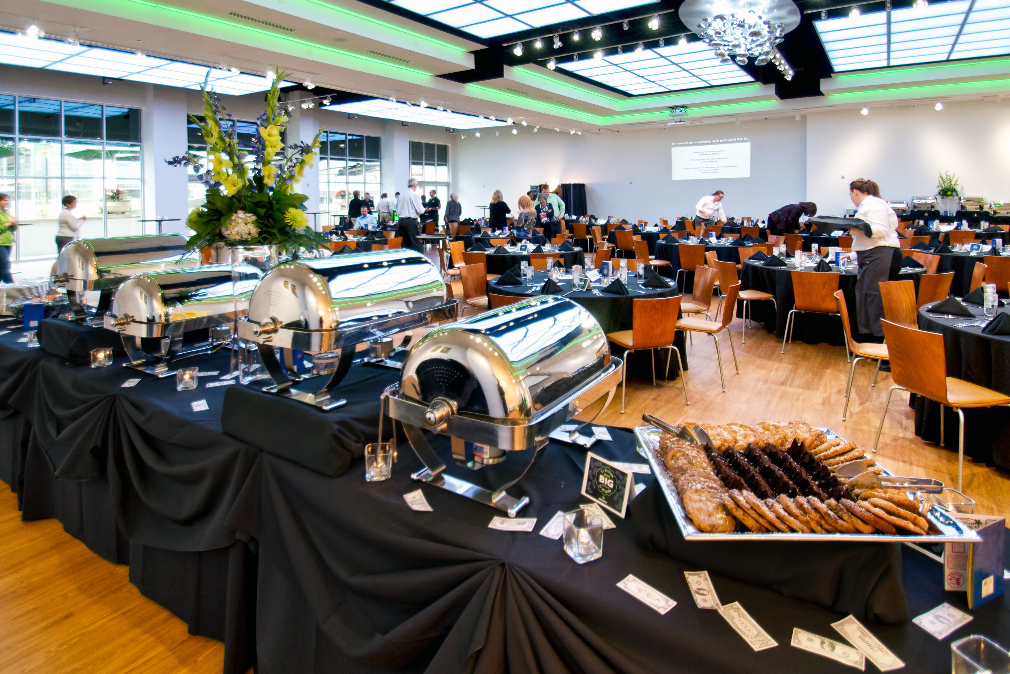 The Gallery set up for a private event with catering tables and projector screen.